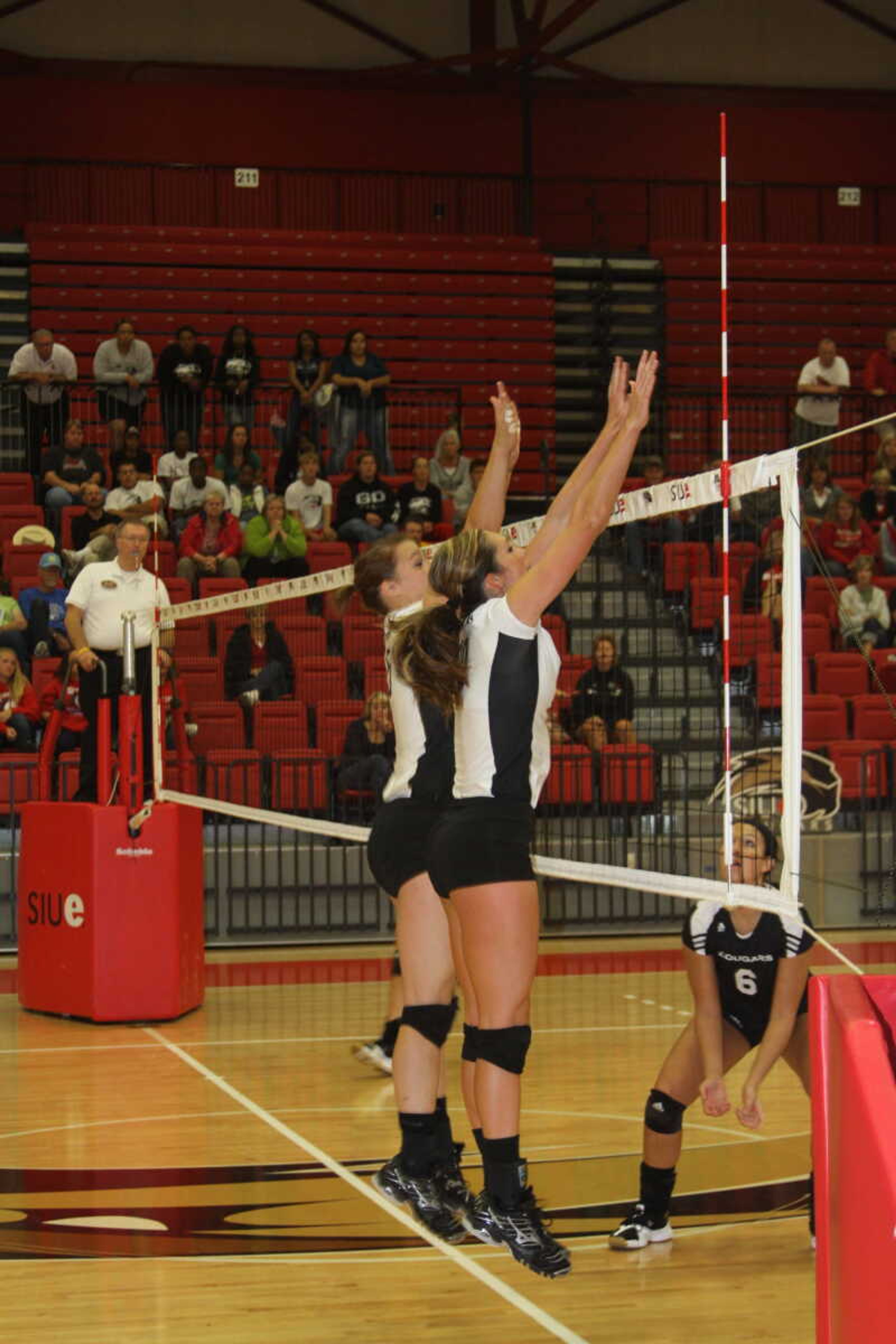 Emily Coon and Paige Dossey attempt to block an SIUE attack. -- Photo by Kelso Hope