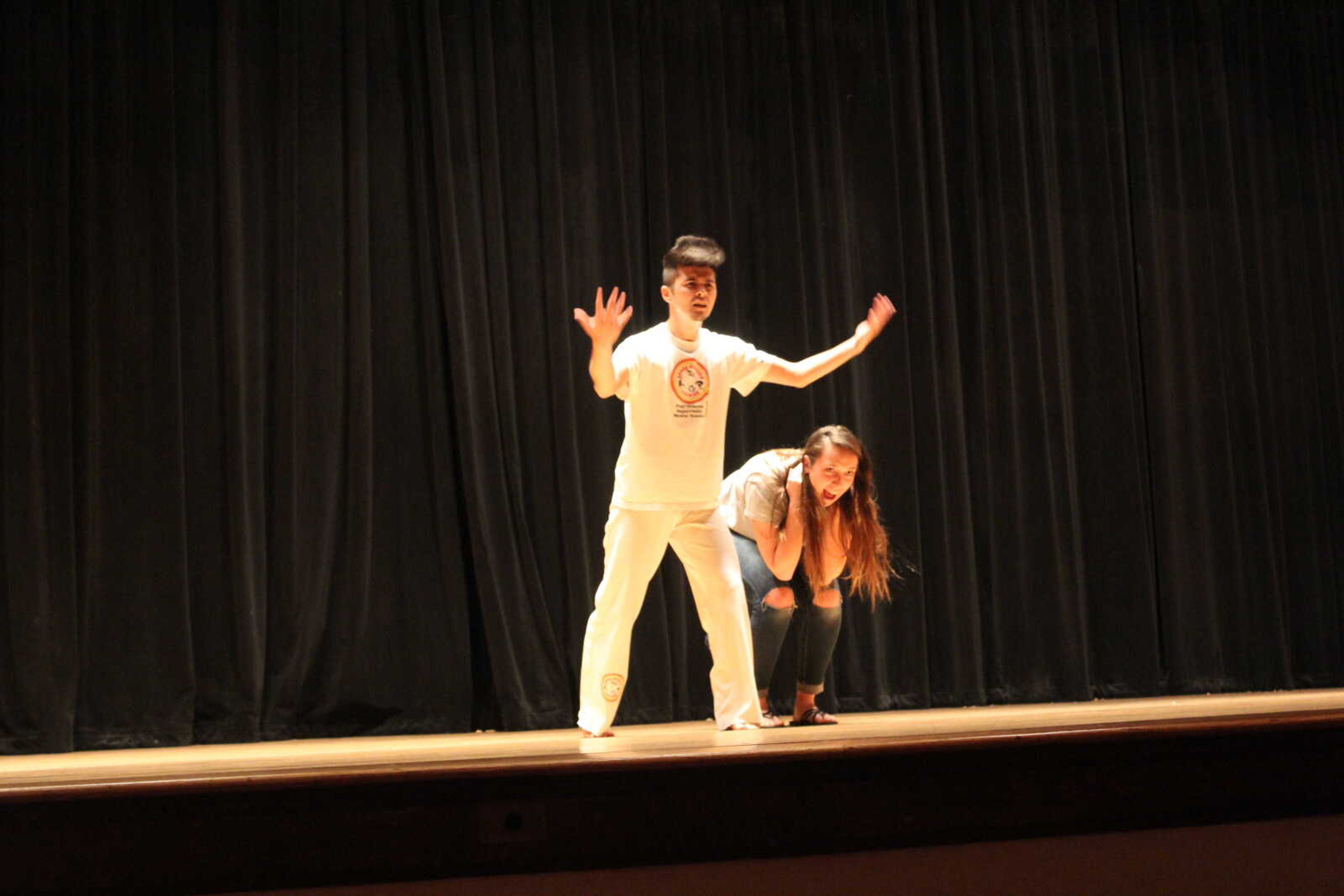 Sophomore Ricardo Ashimi seeks crowd participation as he attempts to jump over Homecoming Planning Committee president Destiny Tulo-Lang's back during his Brazilian martial arts routine at the Homecoming Planning Committe's annual talent show at 7 p.m. on Tuesday, Nov. 2 in the Academic Hall auditorium.