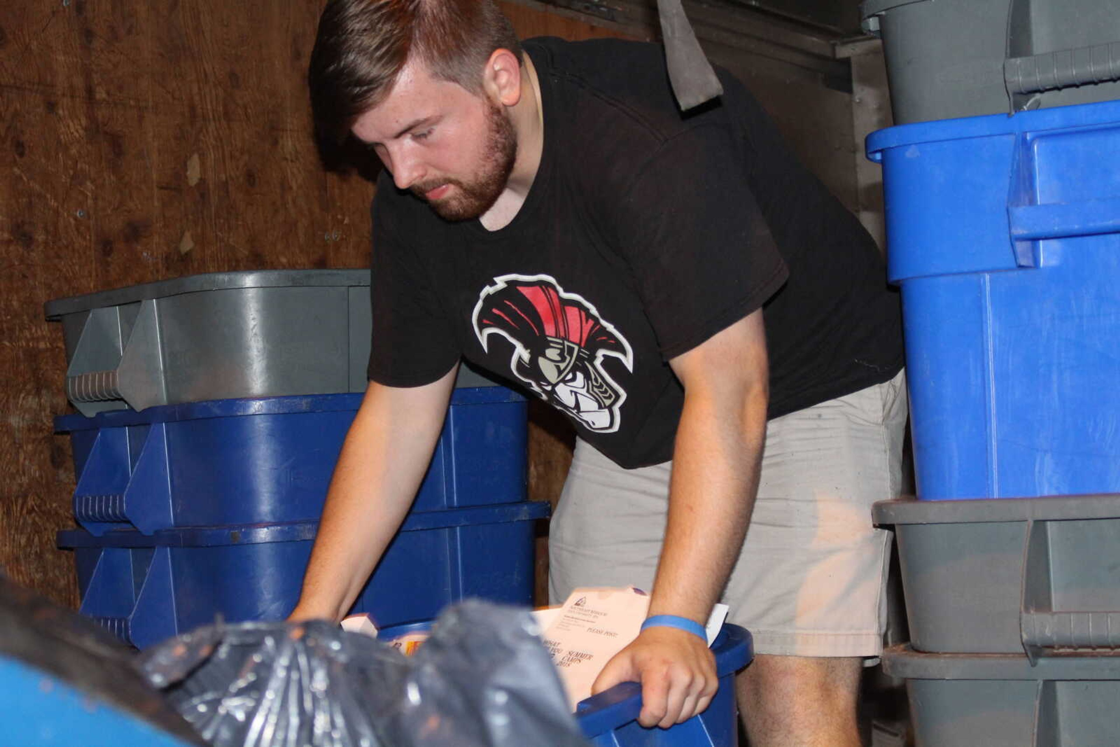 Senior James Grosch, who is employed by Facilities Management, loads up the box truck with recyclable materials Aug. 27.