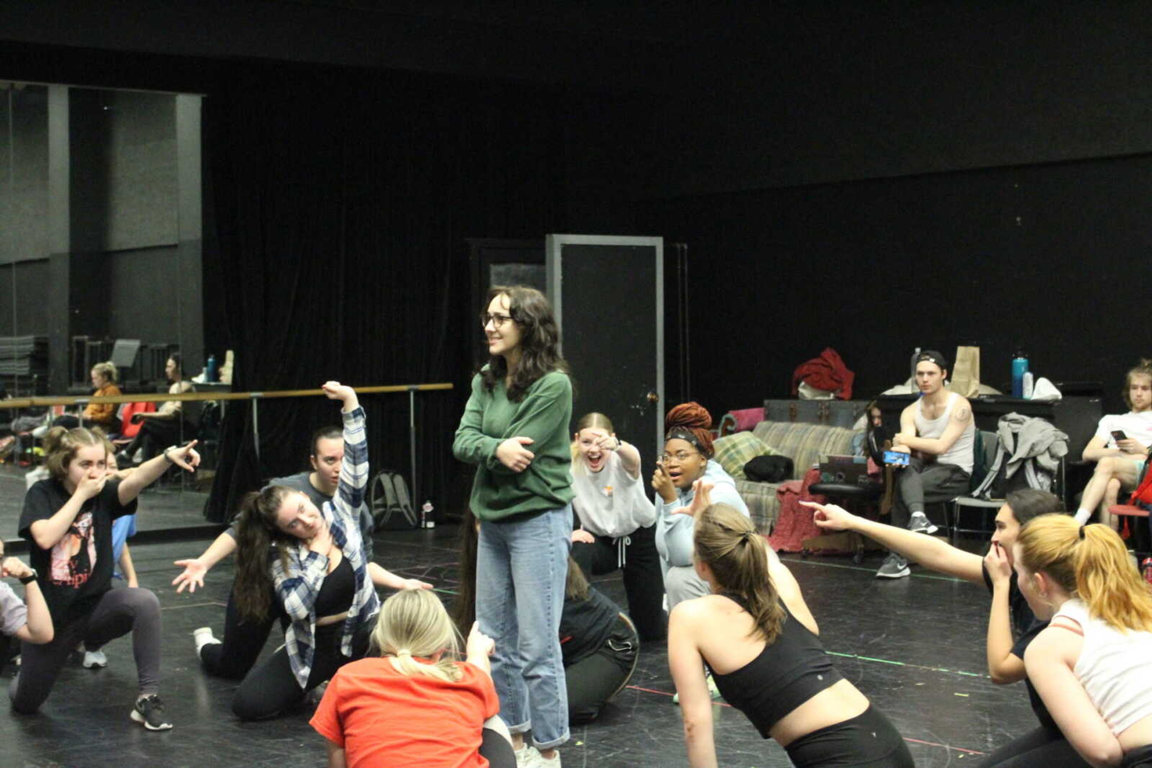 Sophomore musical theater major Caroline Nitardy surrounded by Carrie cast members during a rehearsal. Nitardy has been preparing for the role by reading the Stephen King novel the musical was based off of and exploring the complex emotions behind the character.