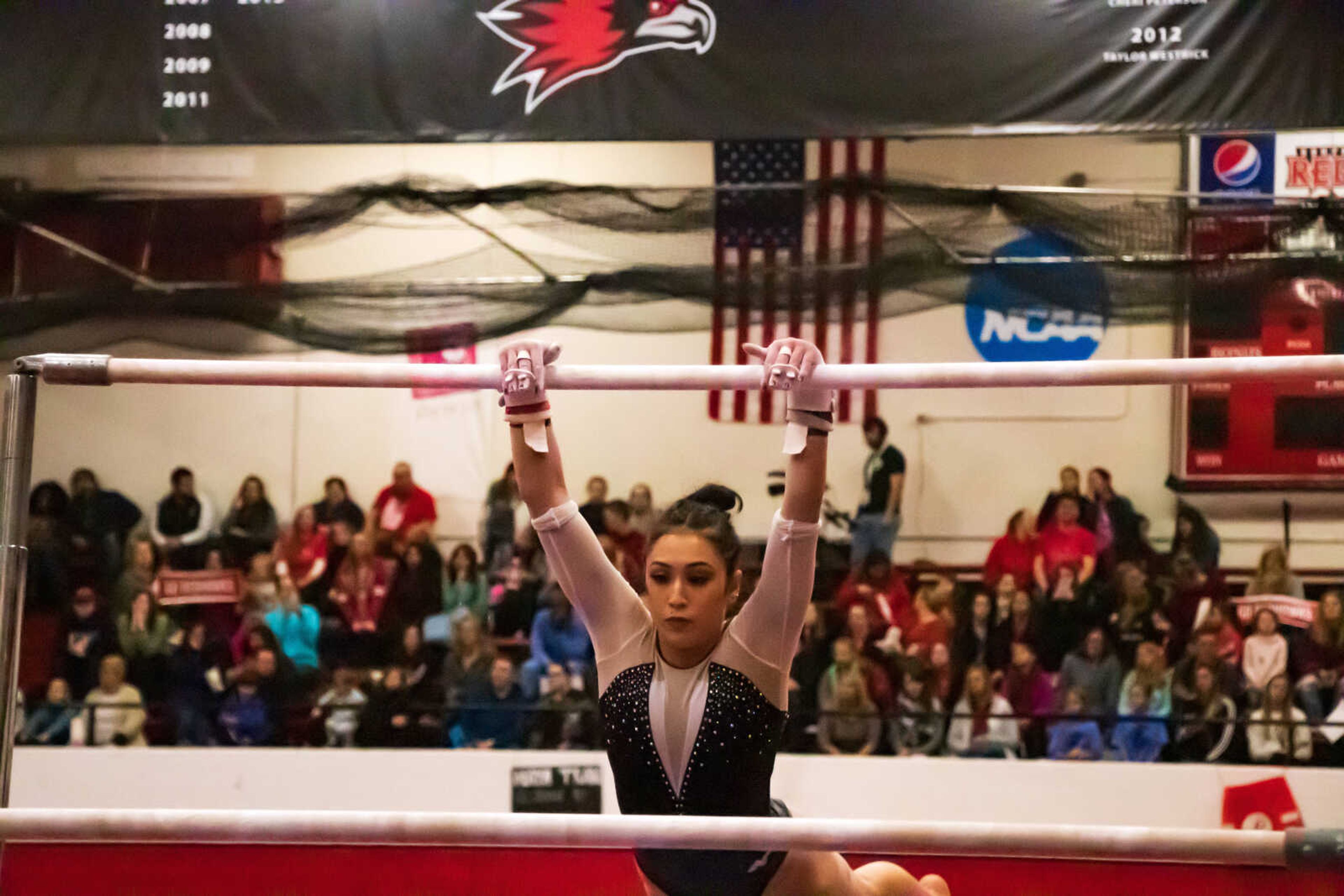 Freshman Maya Tran works her uneven bars routine on Jan. 18 at Houck Field House. Tran finished with an 8.400 in the event, placing last among all competitors. l