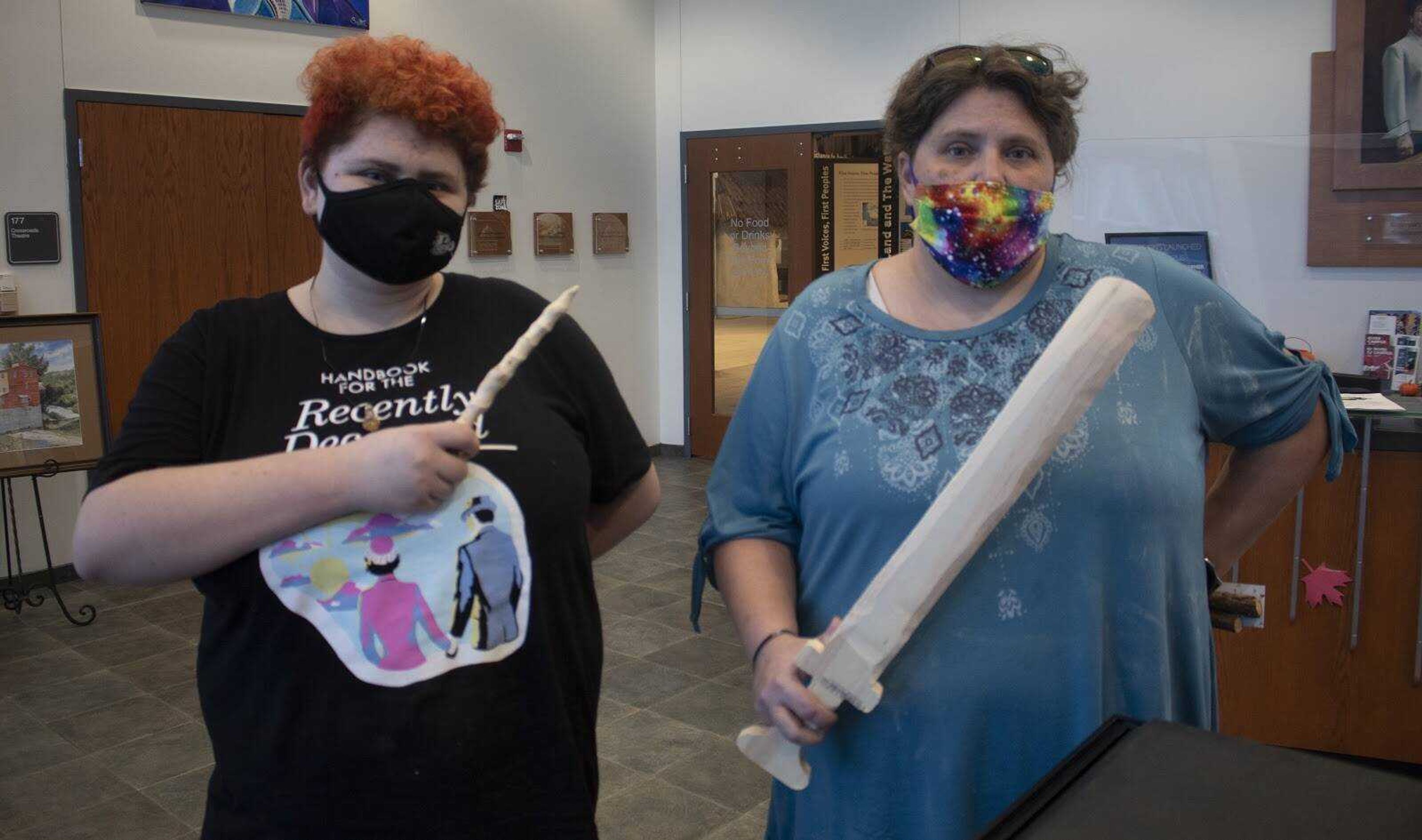 Sammi Parks (left) and Anna Parks hold their wand and sword after the workshop. These projects took roughly an hour to complete, including cutting and sanding. 