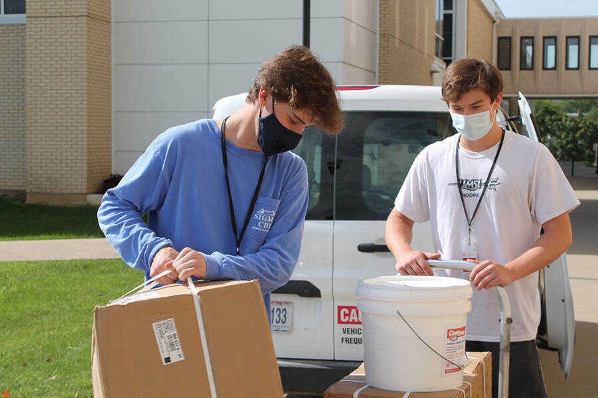 Student employees with Facilities Management, Tom Isaacs (left) and Trevor Fish, deliver materials to Magill Hall of Science Monday, Aug. 17. New positions for student employees will be paid with funds from the Coronavirus Aid Relief and Economic Security (CARES) Act.