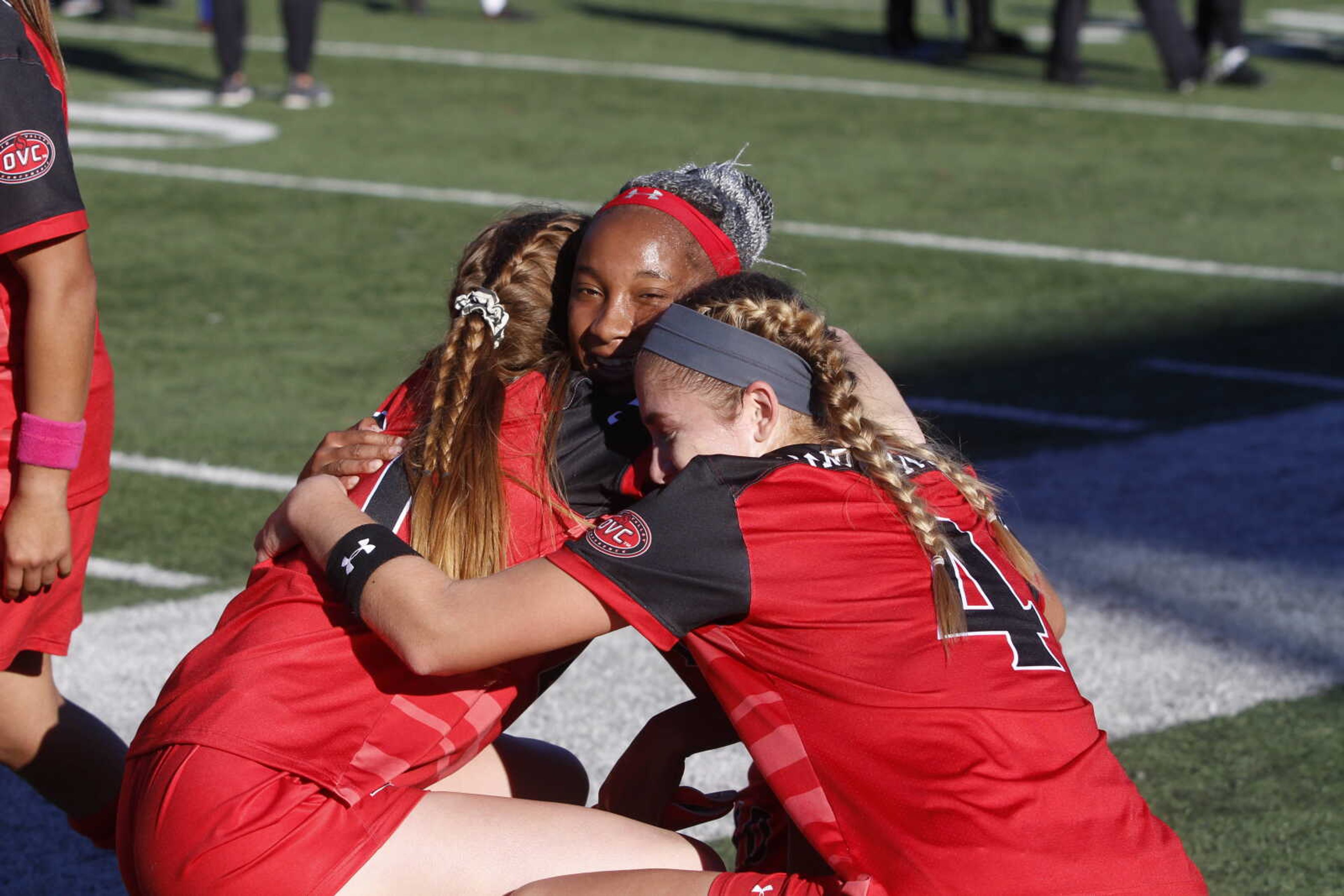 Senior Jermima Job (center) embraces teammates Hannah Compernolle (right) and Katie Wegmann after Southeast's win over Austin Peay on Oct. 21.