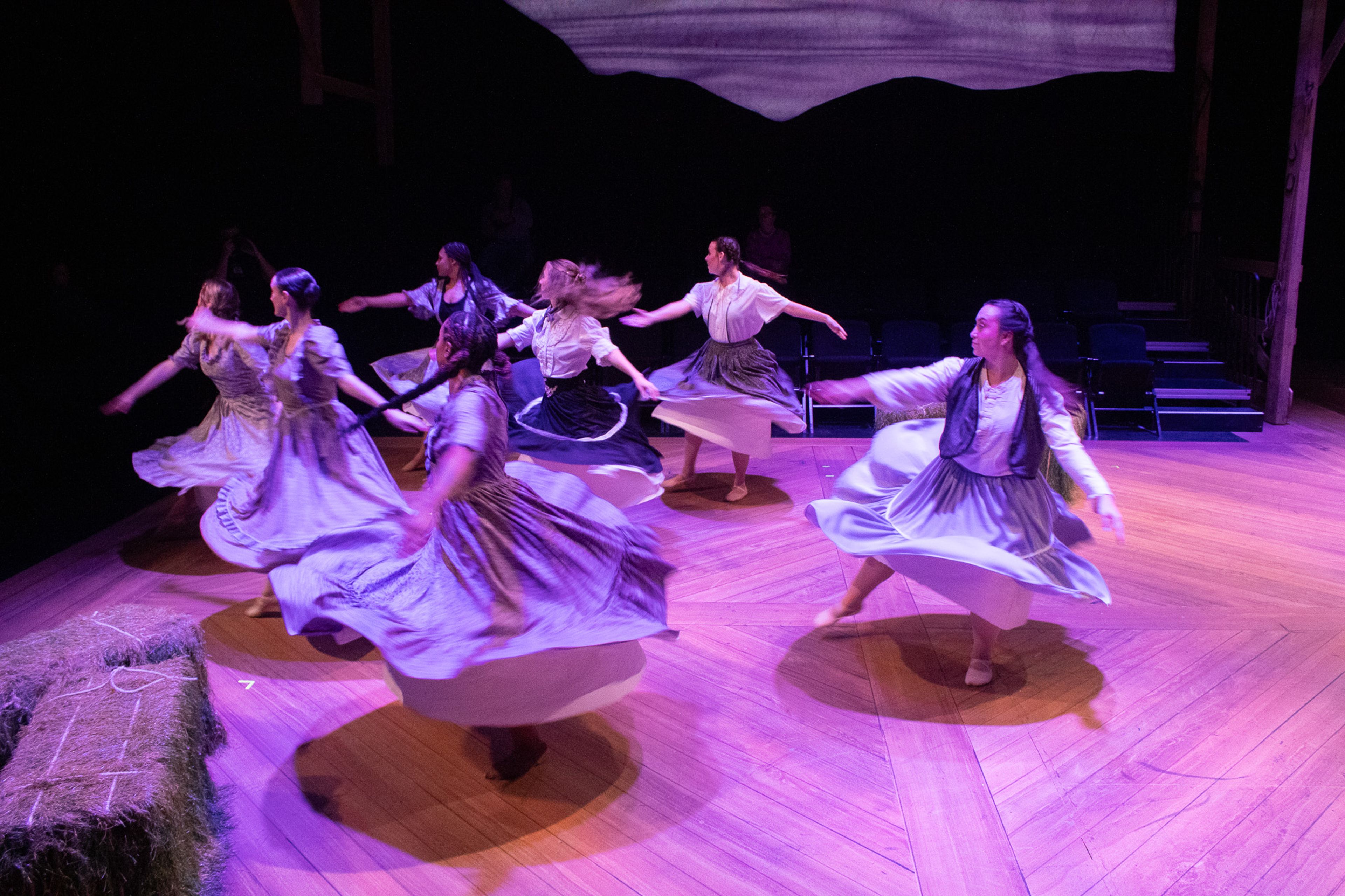 Dancers twirl around as Laurey played by Elise Bowles dreams about what will happen if she goes to the box social with Curly.