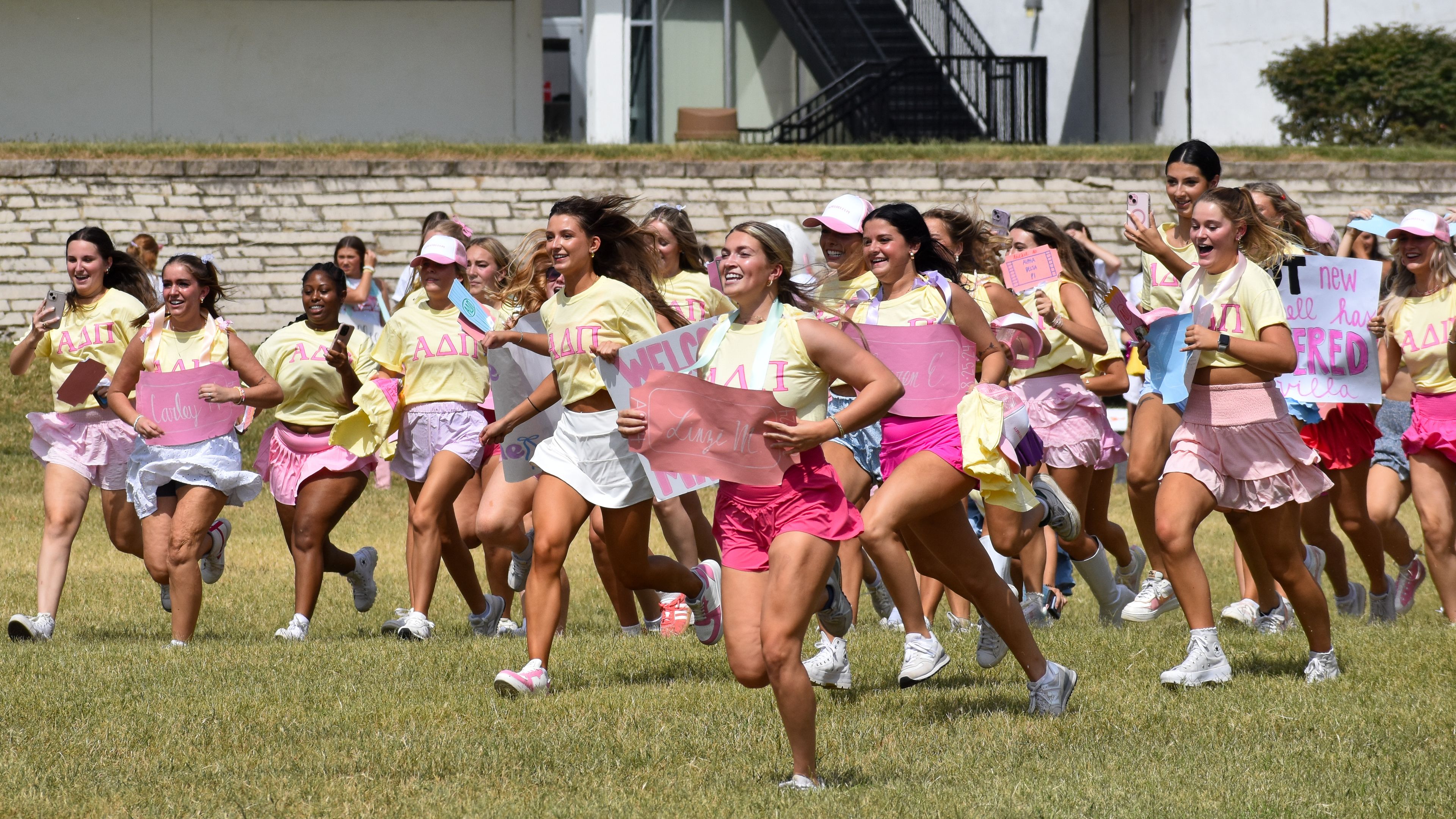 Members of Alpha Delta Pi run to greet their new sisters at Parker Field.