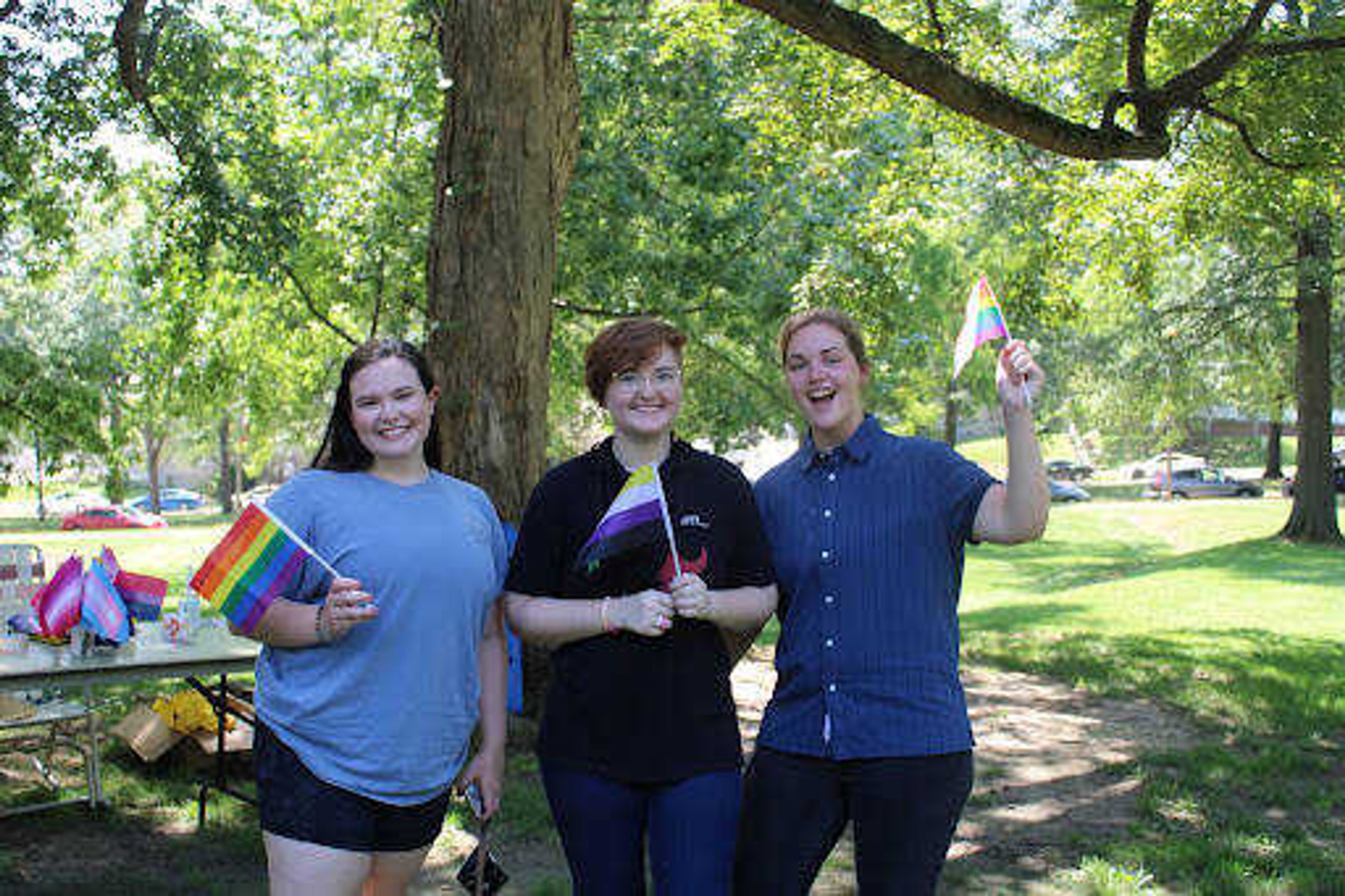 Southeast students wave flags while posing for a photo at the LGBTQ+ and ally picnic on Aug. 25 at the Academic Terraces. Pride flags representing many different identities within the LGBTQ+ community were available at the picnic.