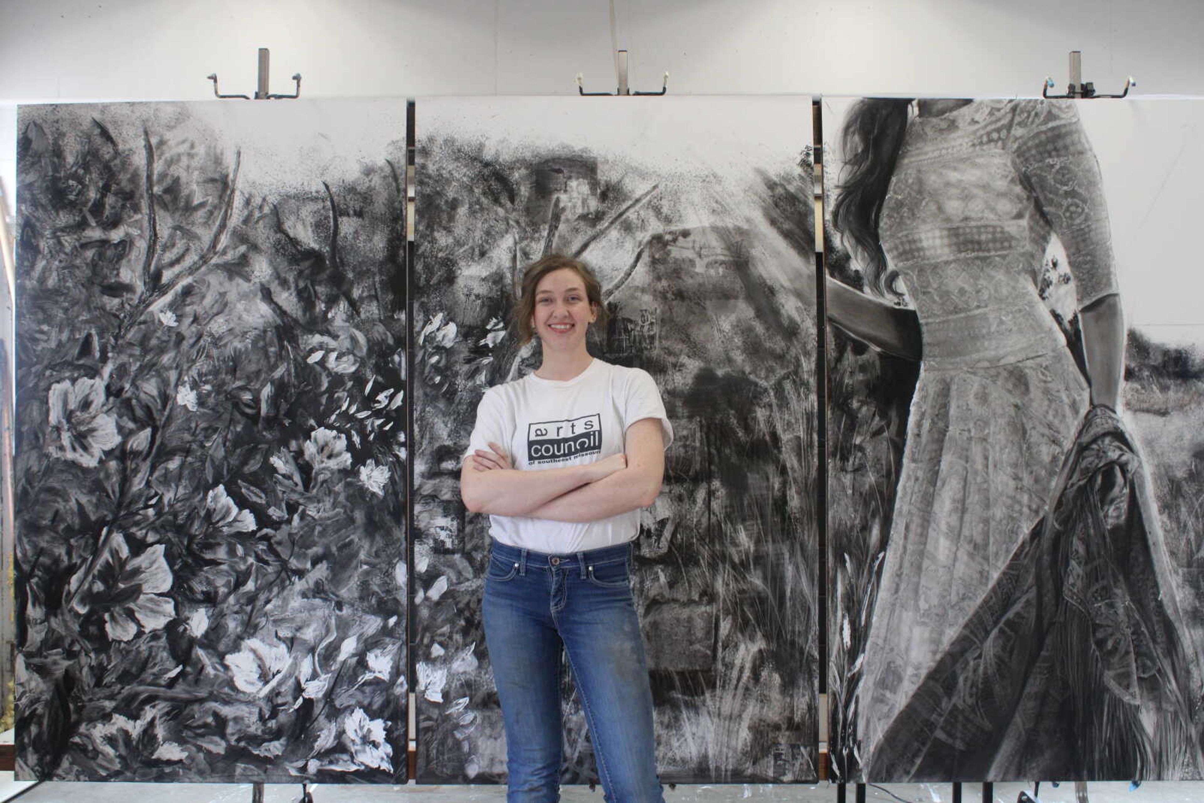 Kate Cooper stands in front of her 10-ft. art piece. The piece took approximately a week to finish.