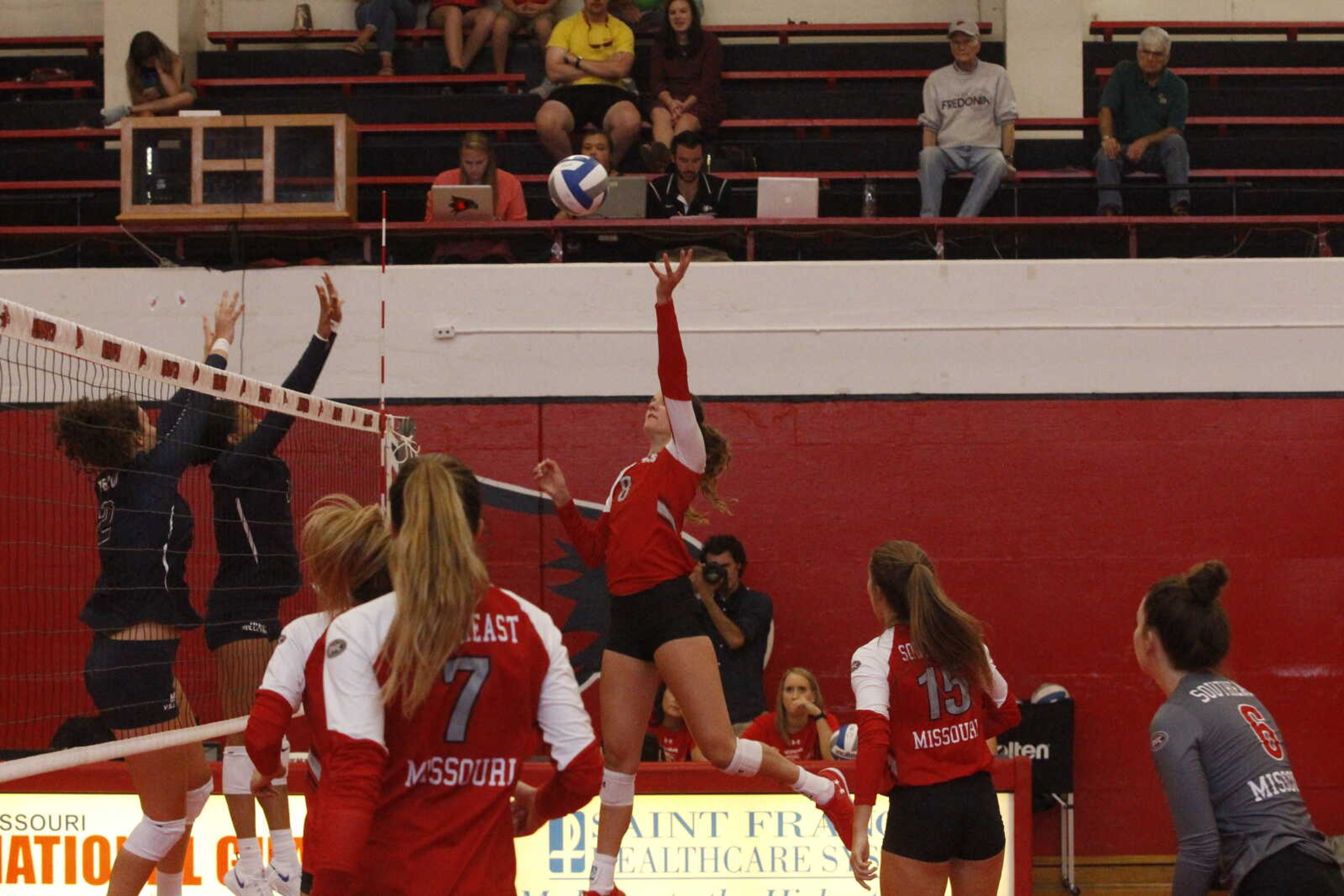 Senior Haley Bilbruck rises to tip a ball over defenders in a victory over Missouri Baptist University on Aug. 13.