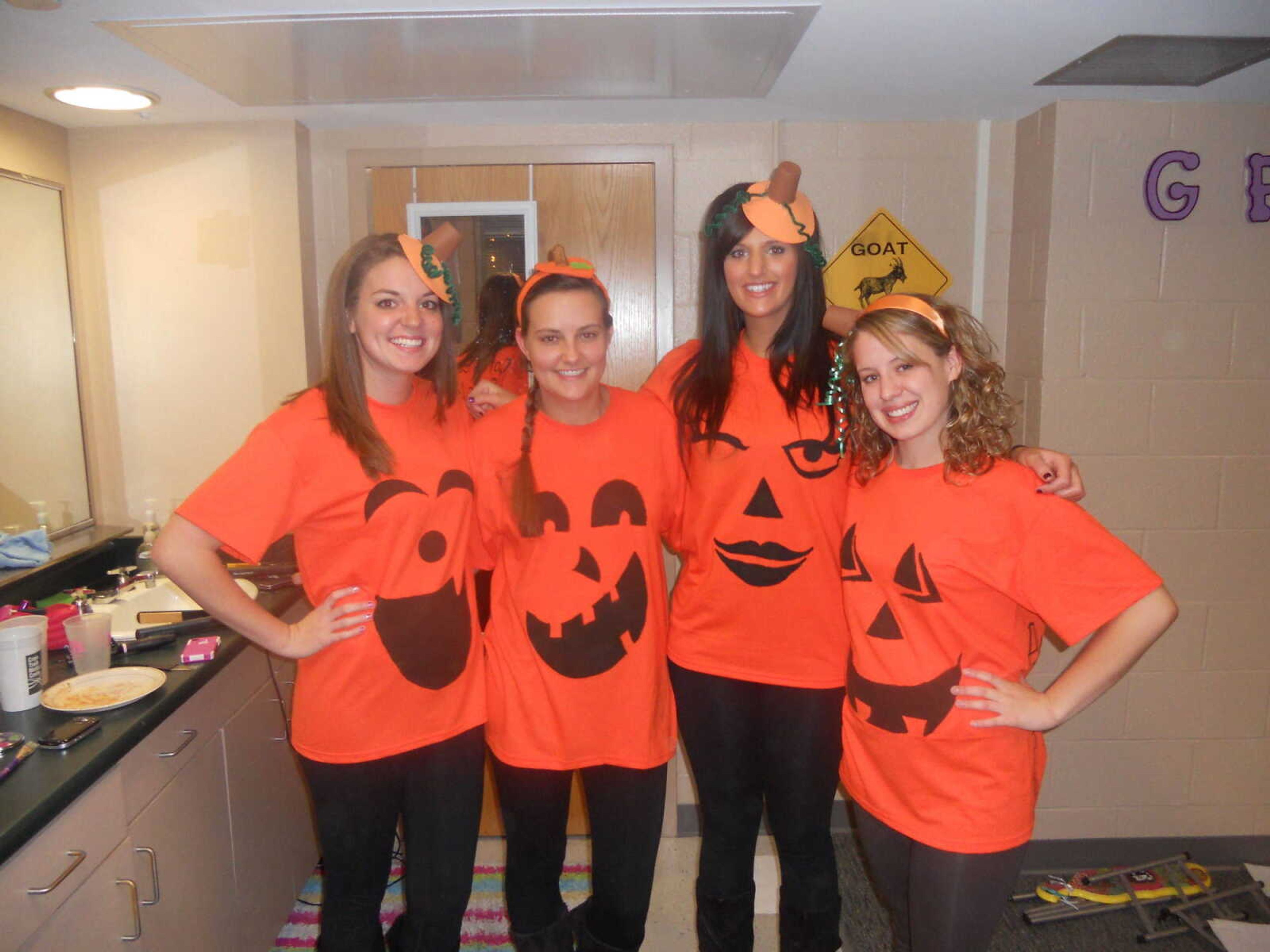 Four Gamma Phi's dress up as pumpkins for Halloween and dance the night away to the Pumpkin Roll!