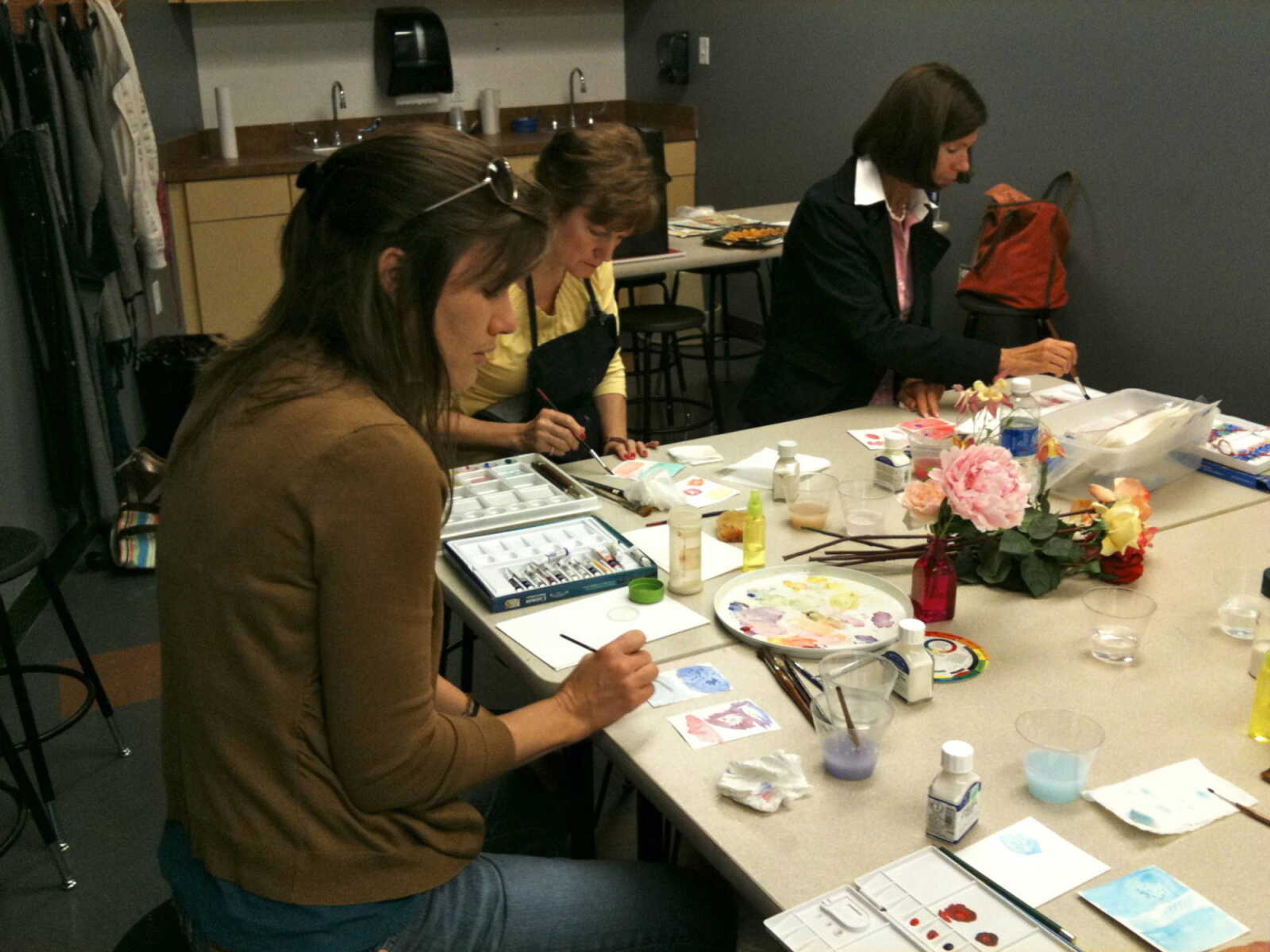 Participants in the 2012 Adult Art Workshops work on watercoloring. Submitted photo