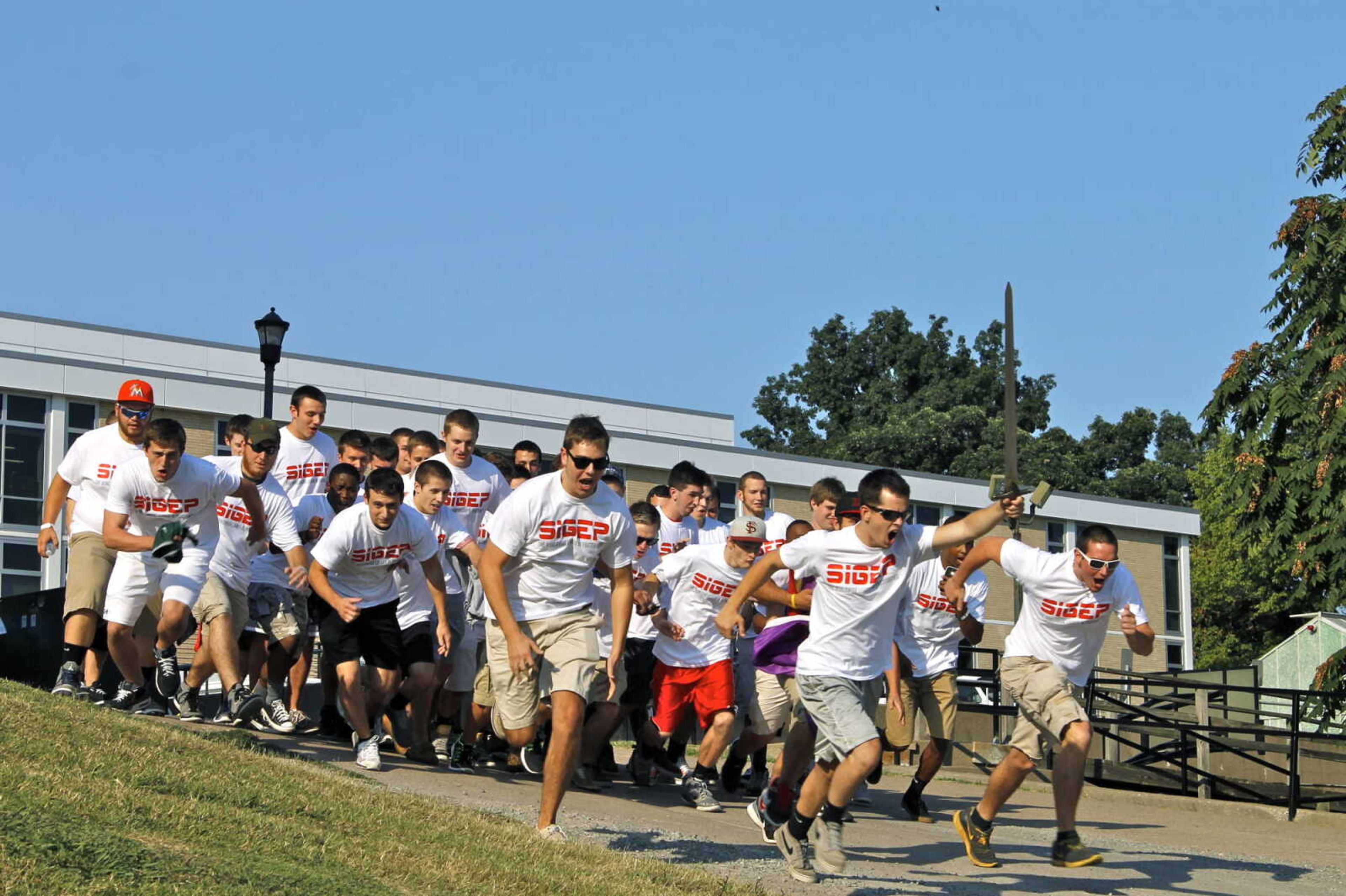 <b>Sigma Phi Epsilon brothers run to meet their pledges on Bid Day, Sept. 6. </b> Photo by Drew Yount