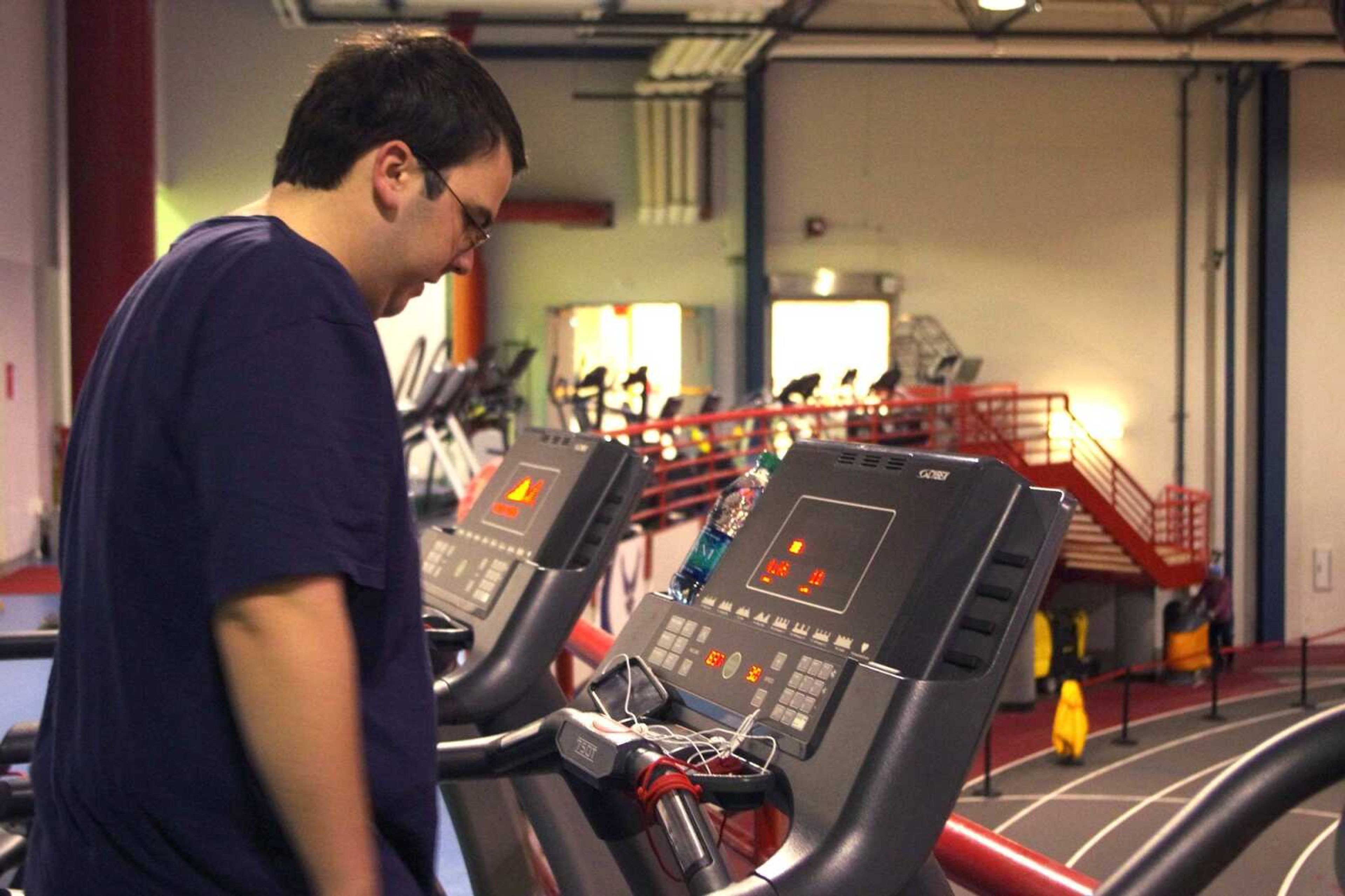 Mike Rokicki, hall director of Merick Hall, works out on the treadmill at the Student Recreation Center-North. Photo by Nathan Hamilton