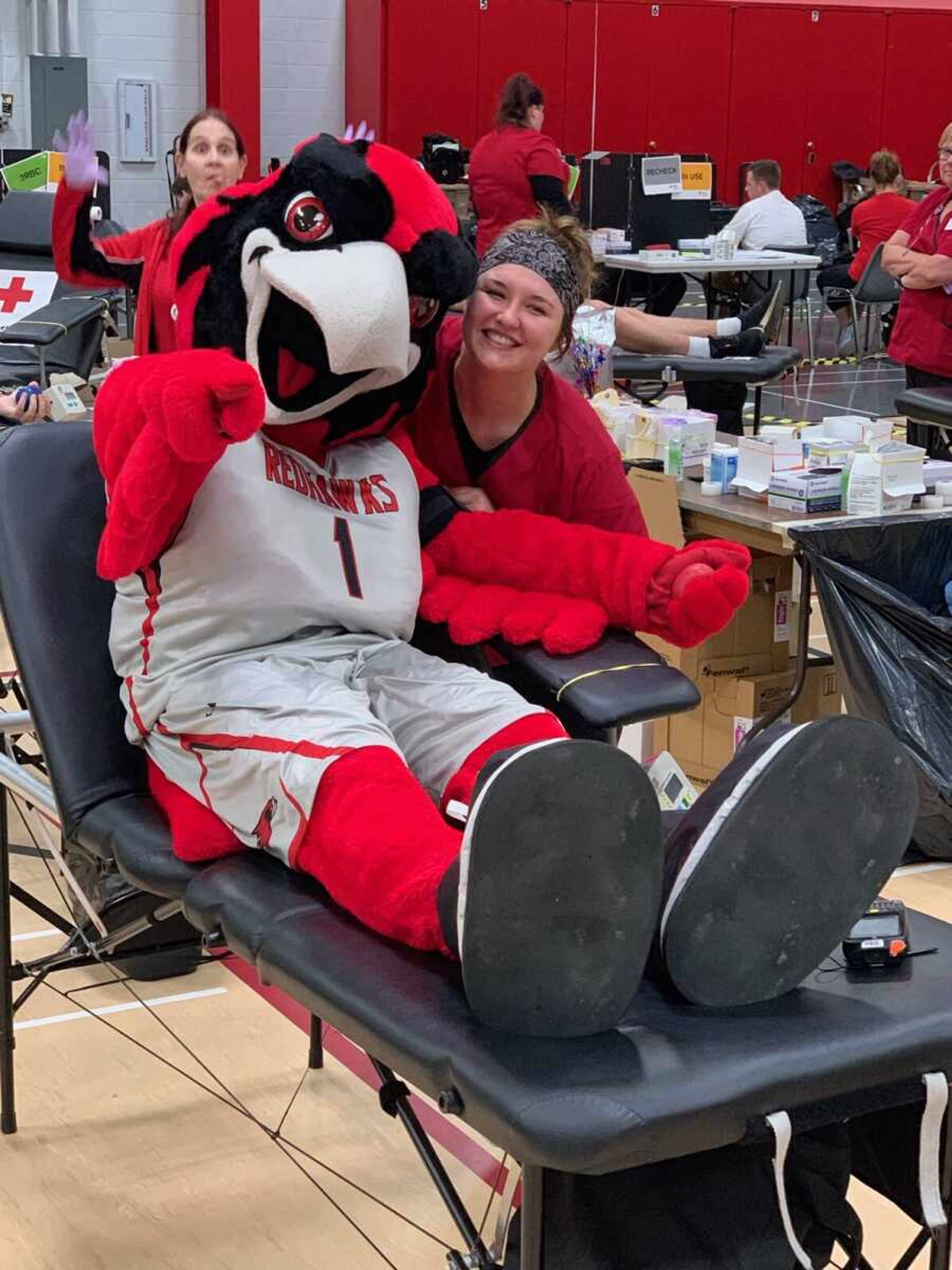 Southeast mascot Rowdy the Redhawk poses with a volunteer at a past blood drive.