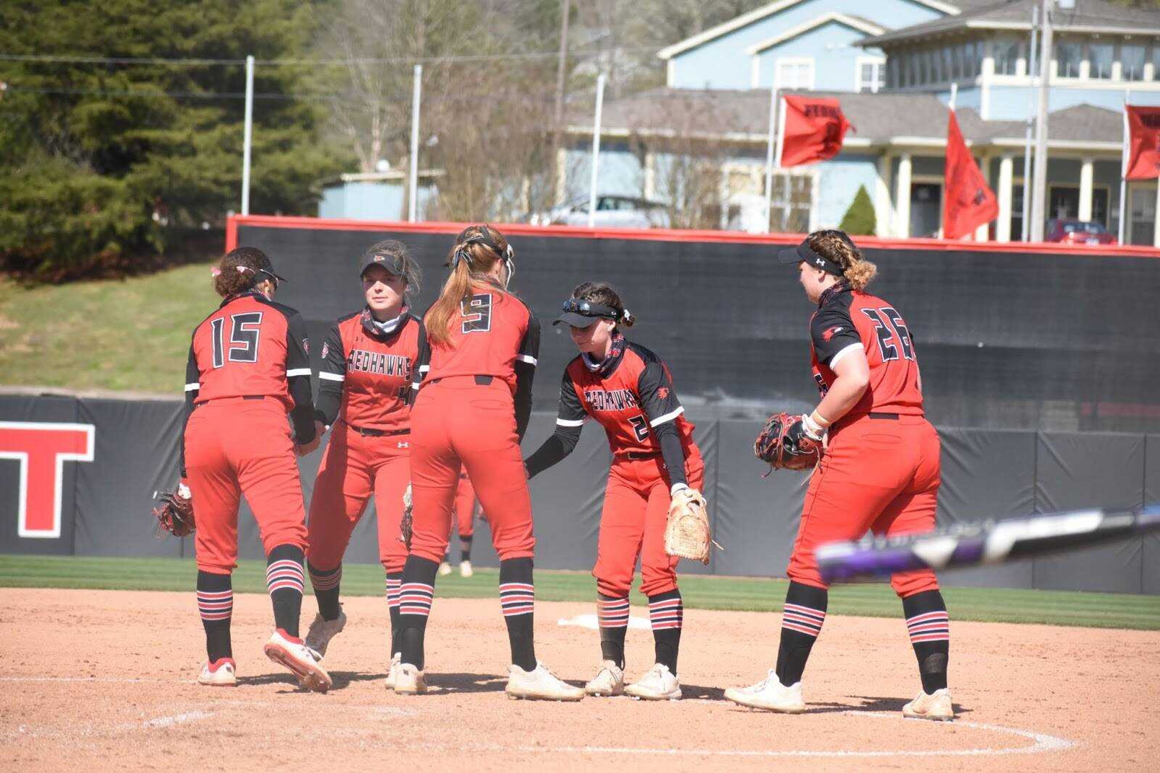 The Redhawks meet in the pitcher's circle prior to the start of an inning during a 5-0 win over Southern Illinois on March 31 at the Southeast Softball Complex in Cape Girardeau.