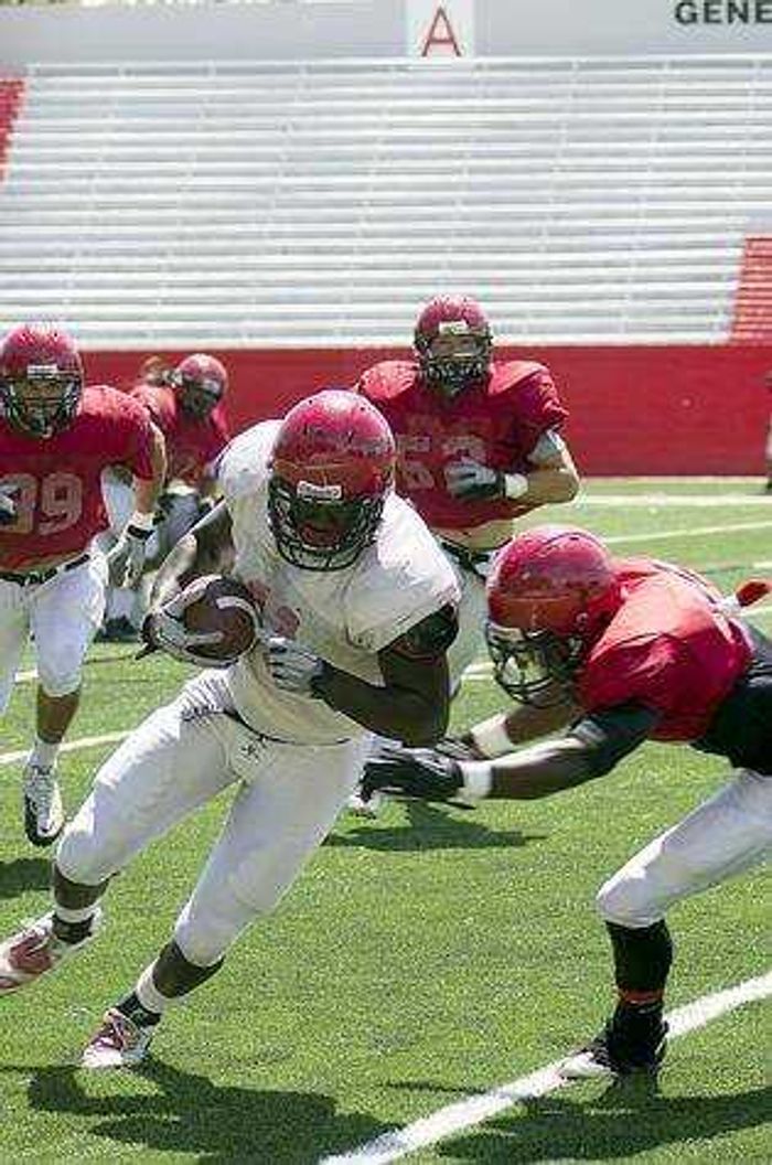 Wide receiver Elijah Jackson avoids a tackle during the team's scrimmage. Photo by Nathan Hamilton