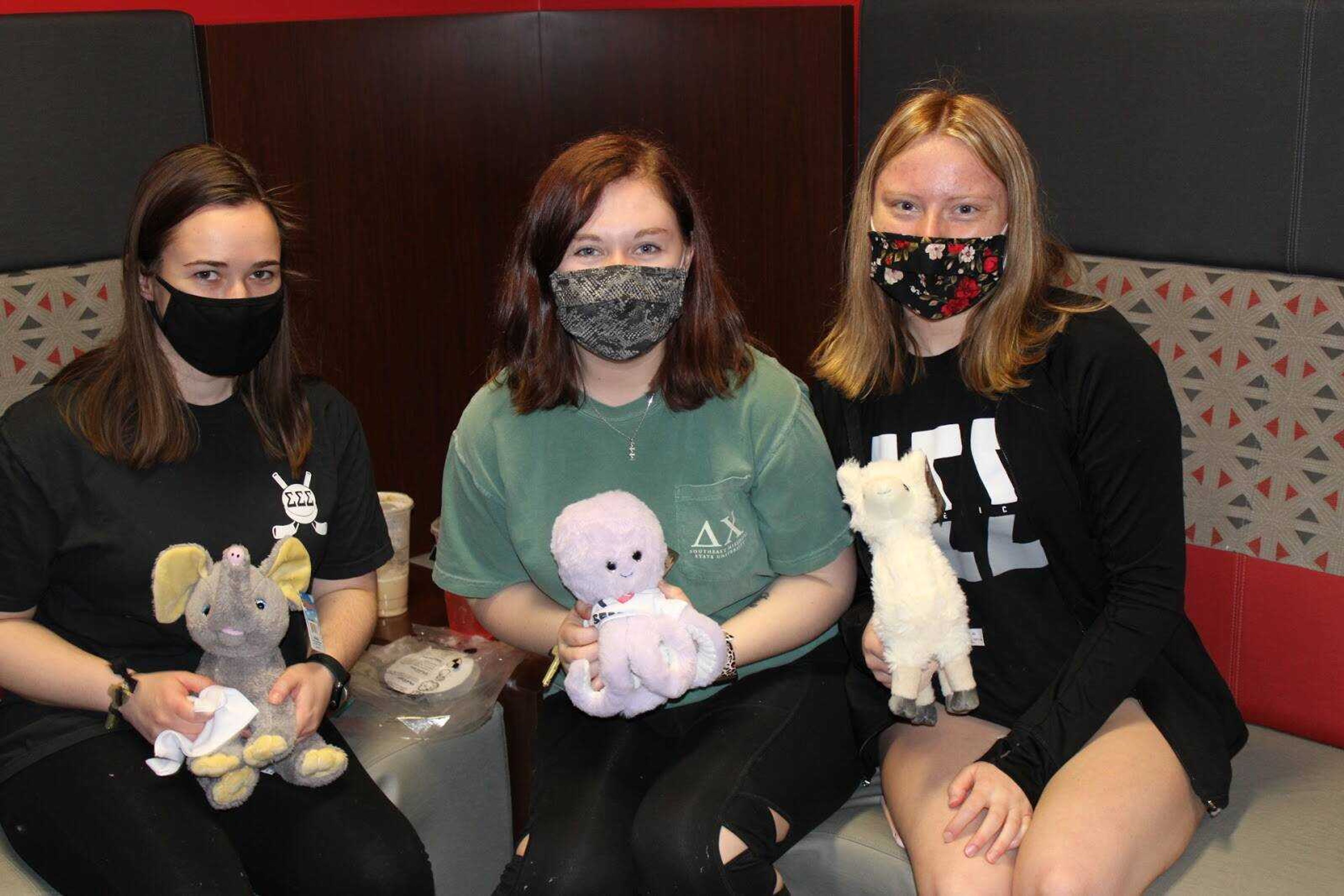 Katherine Ramberger, Paige Pendleton and Mackenzie Ranchel pose with their new cuddle friends. 