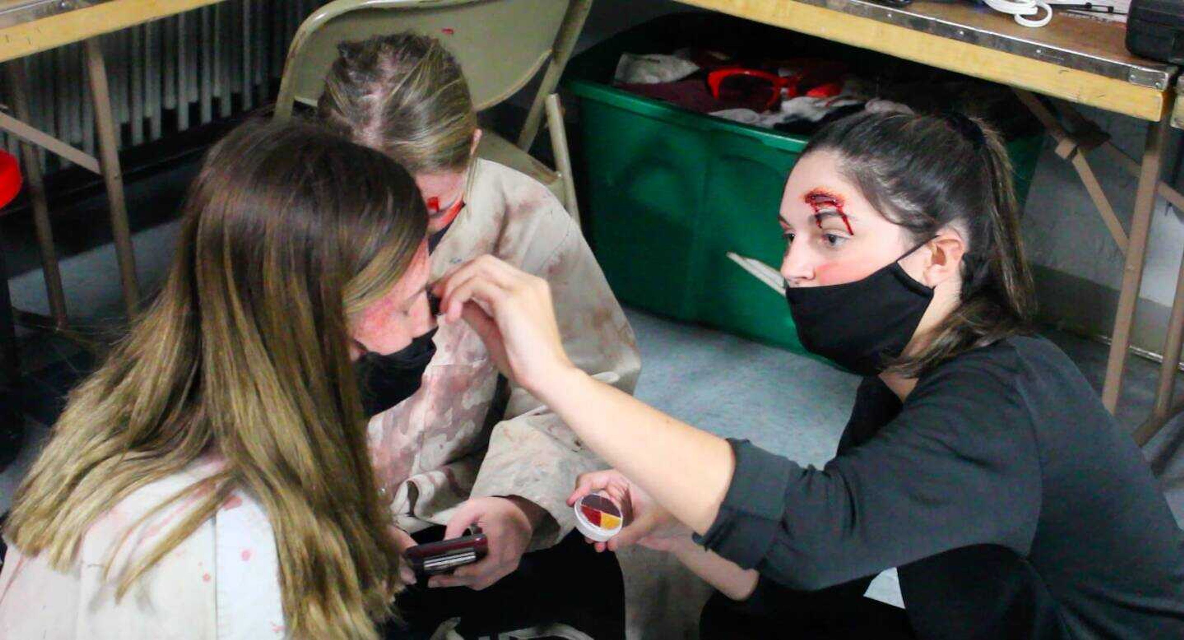 Southeast junior Caitlin Helterbrand helps other volunteers put on makeup for the 29th annual Haunted Hall of Horror at the A.C. Brase Arena on Thursday, Oct. 22, 2020, in Arena Park.
