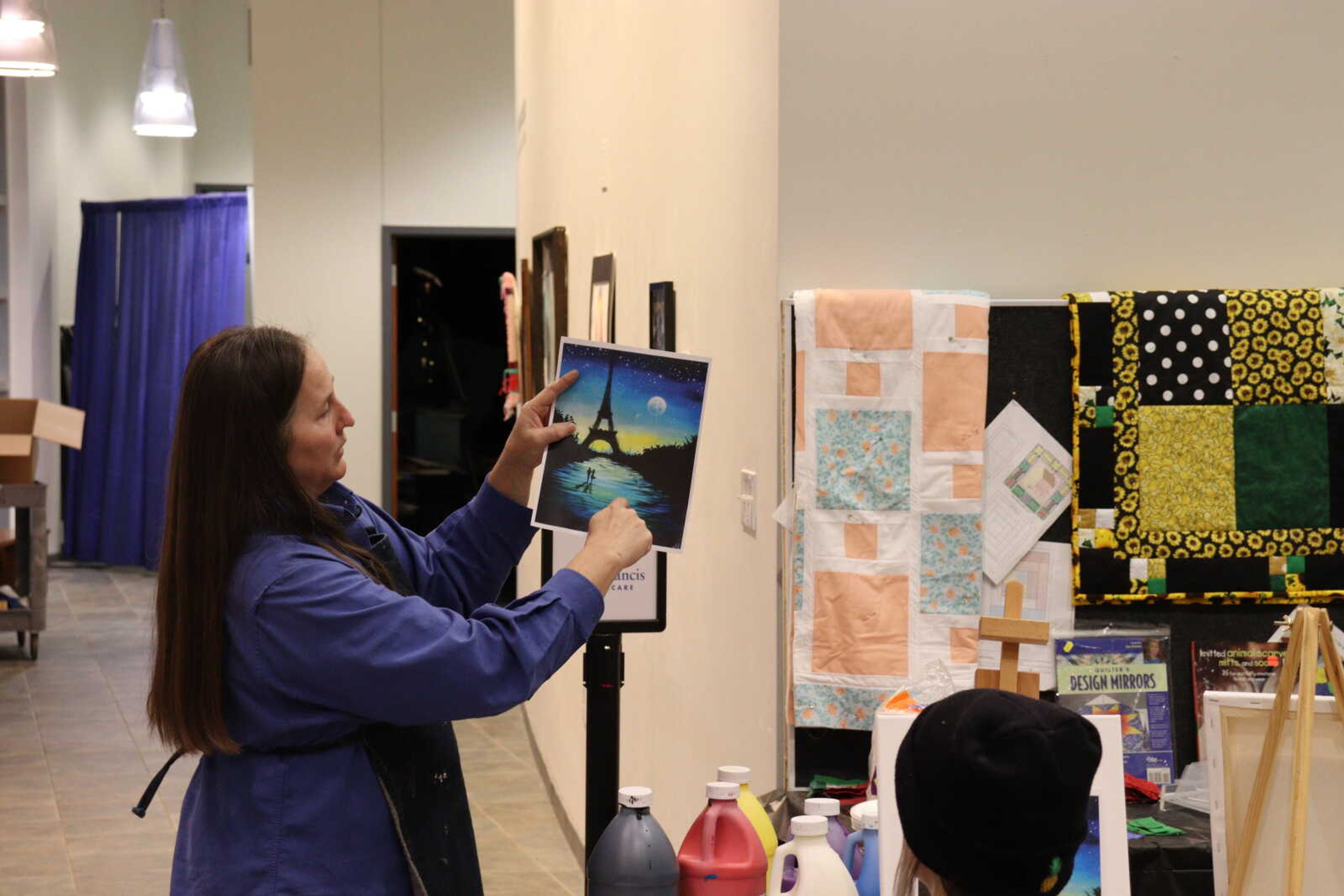 Curator of education at Crisp Museum Ellen Flentge teaches the class how to blend colors seamlessly.
