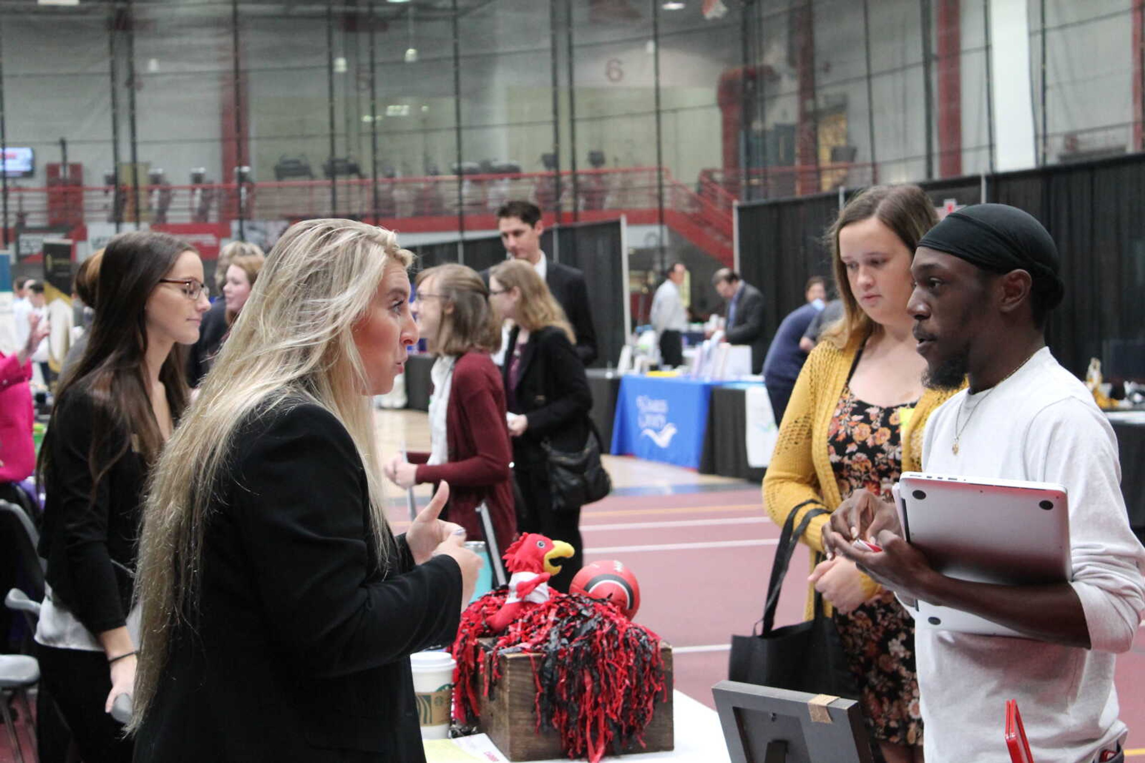 Southeast students Martin Woods and Danielle Thiemp talk with Alicia Ticer, Director of Marketing and Student engagement at Chartwells during Southeast's Fall Career Expo at the Show Me Center on Thursday Oct. 10 in Cape Girardeau, Missouri.