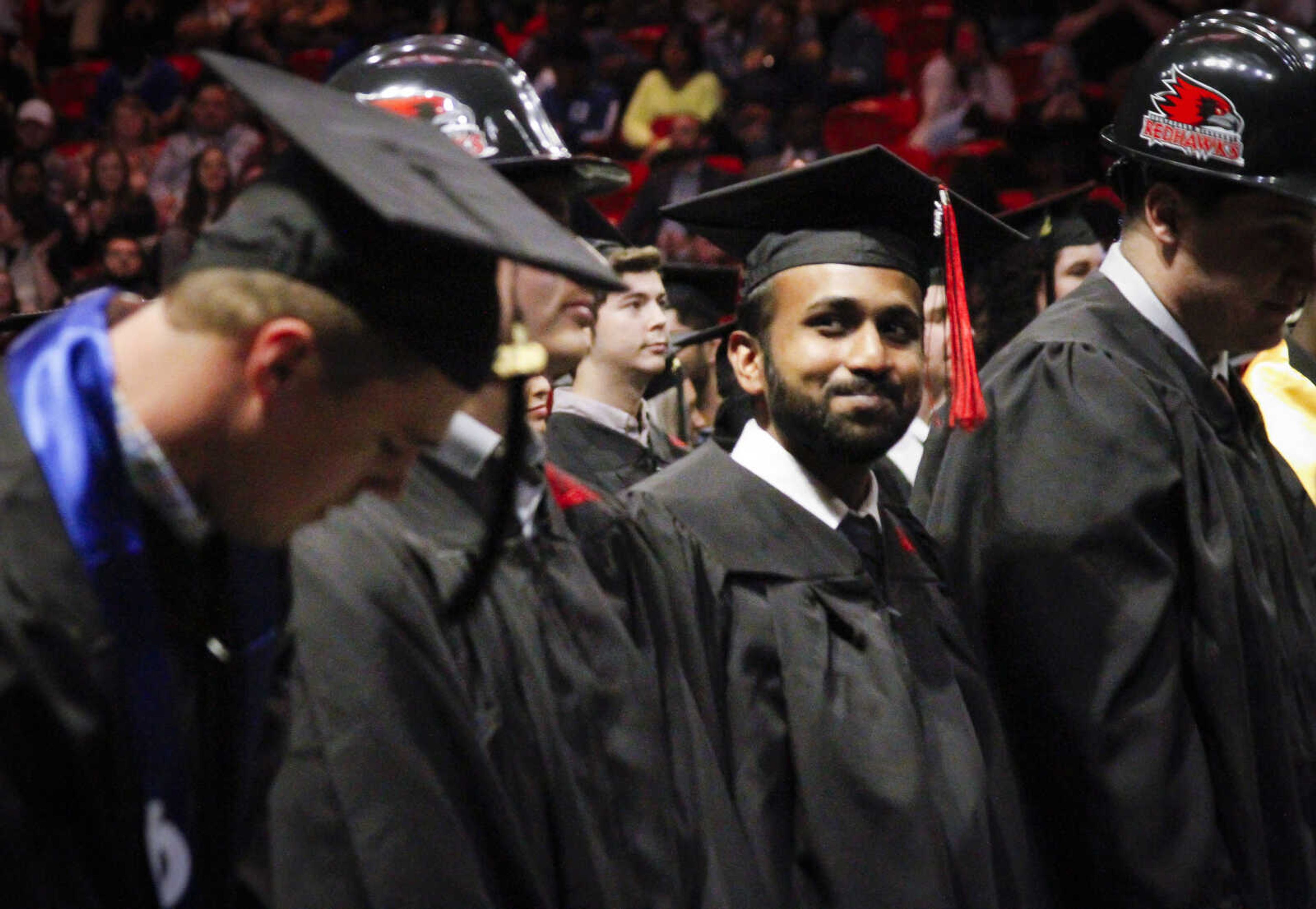 A graduation candidate gazes towards the audience at Southeast Missouri State University's winter commencement ceremony on Saturday, Dec. 14, at the Show Me Center in Cape Girardeau, Missouri.