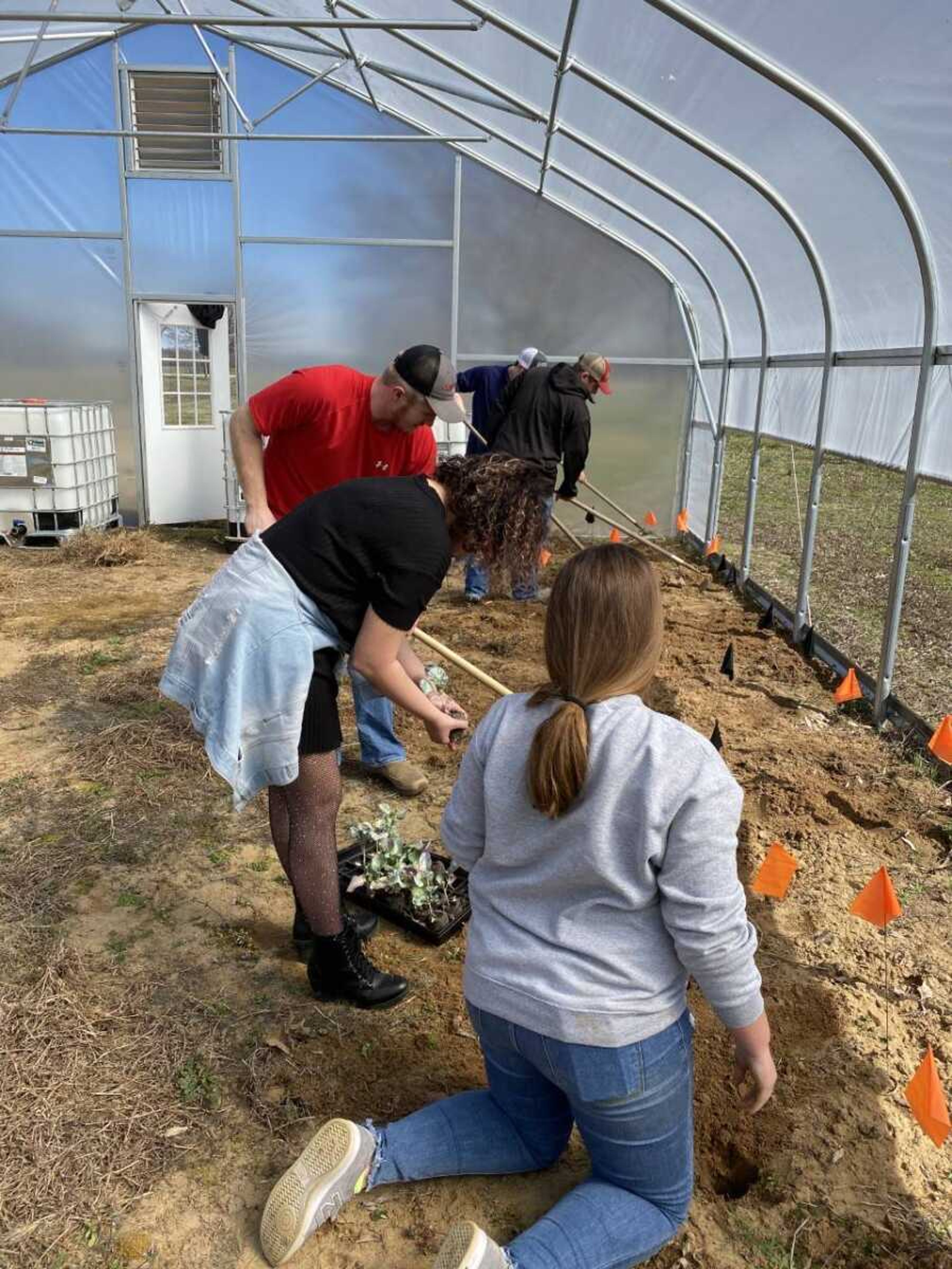 Student volunteers planting and working the garden grounds at the Kennett regional campus.