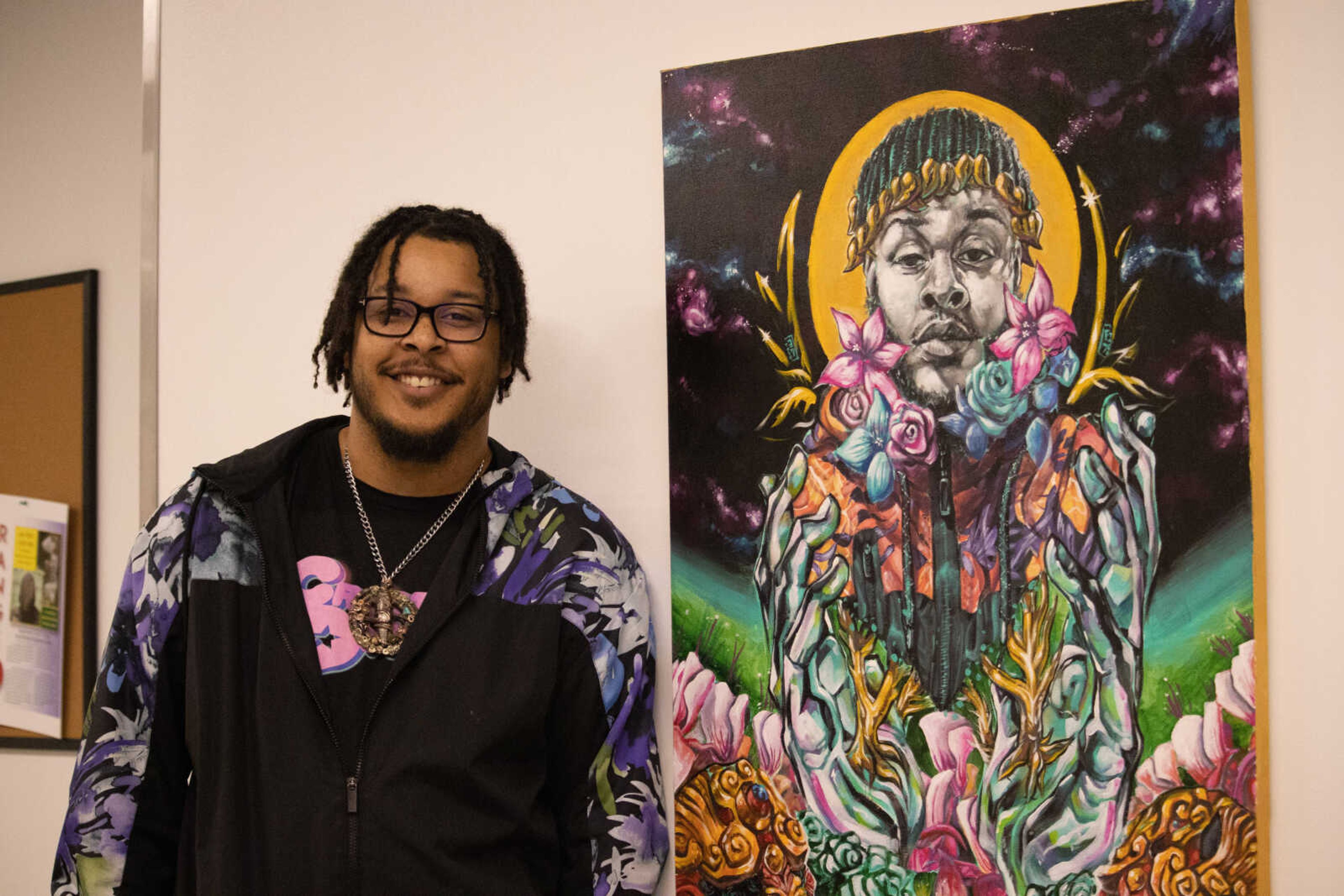SEMO alum and artist Tyler Harris poses next to his art piece, “Rebirth.” Harris graduated from SEMO in 2016 with a degree in Art Education, and is currently a middle school art teacher. All of Harris’s featured works in his gallery are for sale, ranging from $300 to $2200.