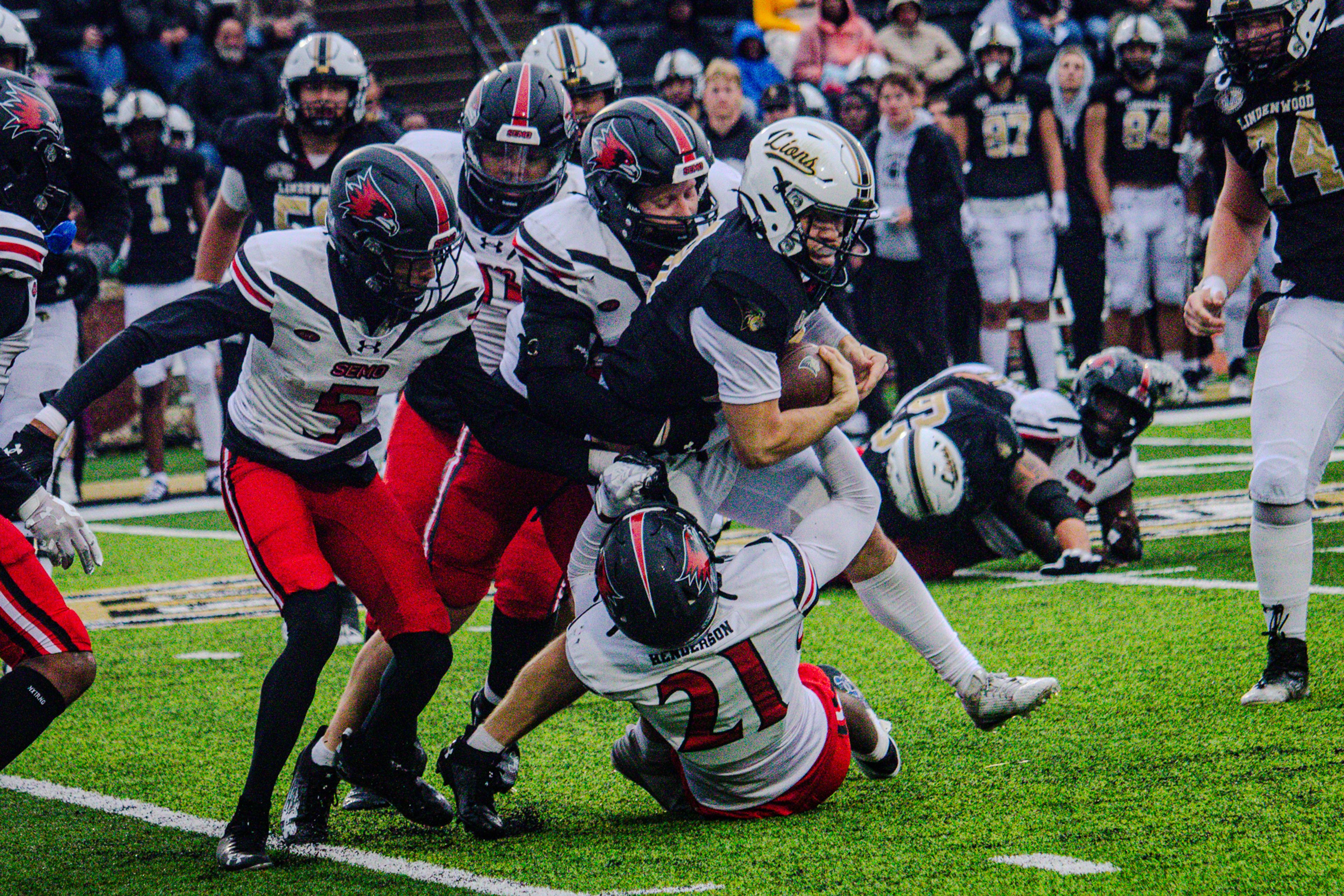 SEMO's defense combines for a tackle against Lindenwood's quarterback. 