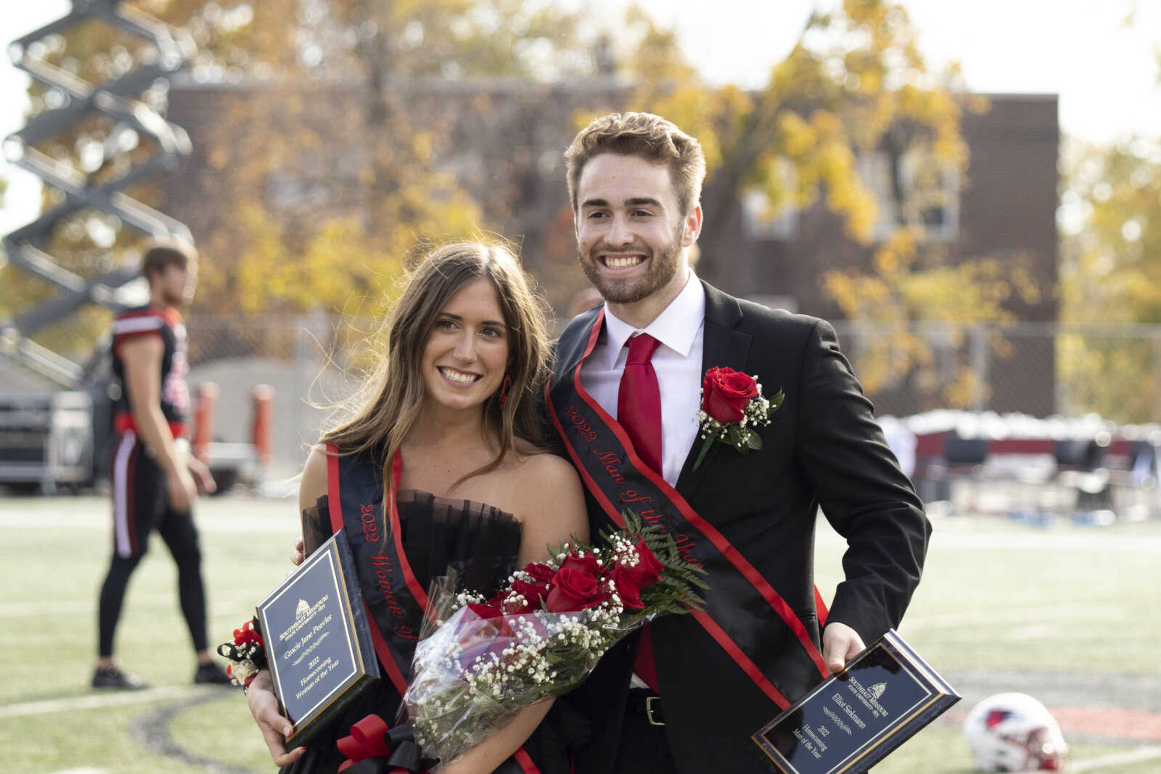 (Left)Homecoming Woman of the Year Gracie Jane Peavler and Man of the Year Elliot Siekmann stand in the middle of Houck Field while they have their pictures taken on Oct. 29. They were handed roses and plaques from University President Carlos Vargas for their big moment at halftime in the Redhawk's Homecoming football game.