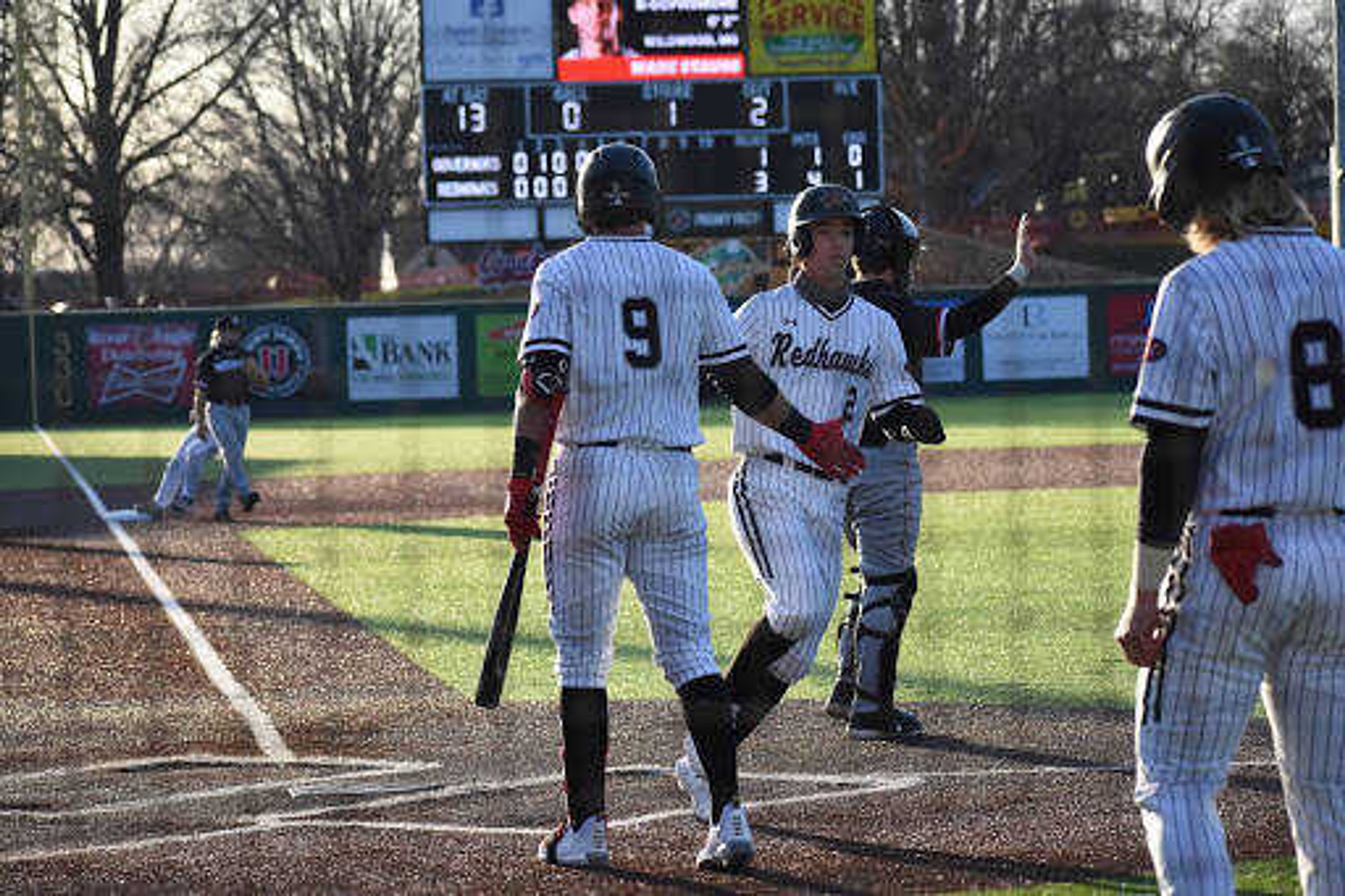 Tyler Wilber (9) hi-fives Connor Basler (2) as Basler crosses the plate during Southeast's 6-3 win over Austin Peay on March 19 at Capaha Park in Cape Girardeau.