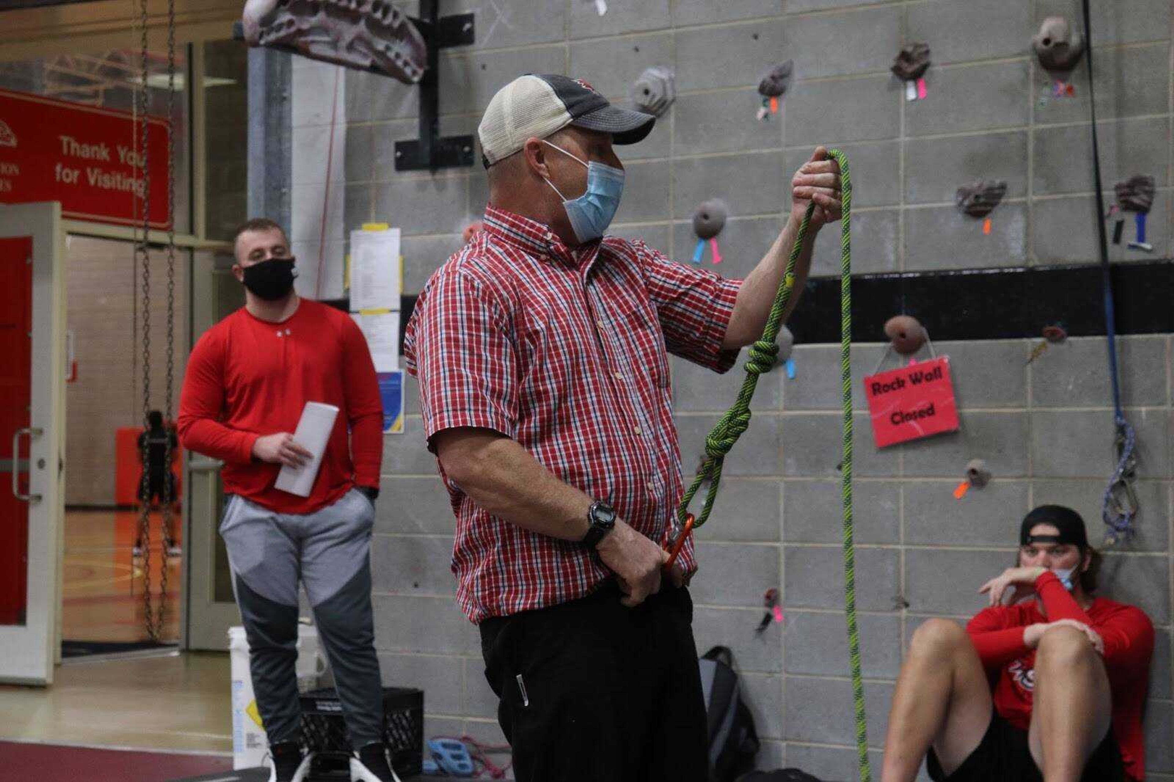 Professor Thomas Holman demonstrating how to tie knots for rock climbing. Students learn about various knots and their uses for rock climbing in AT 174, Rock Climbing and Rappelling.