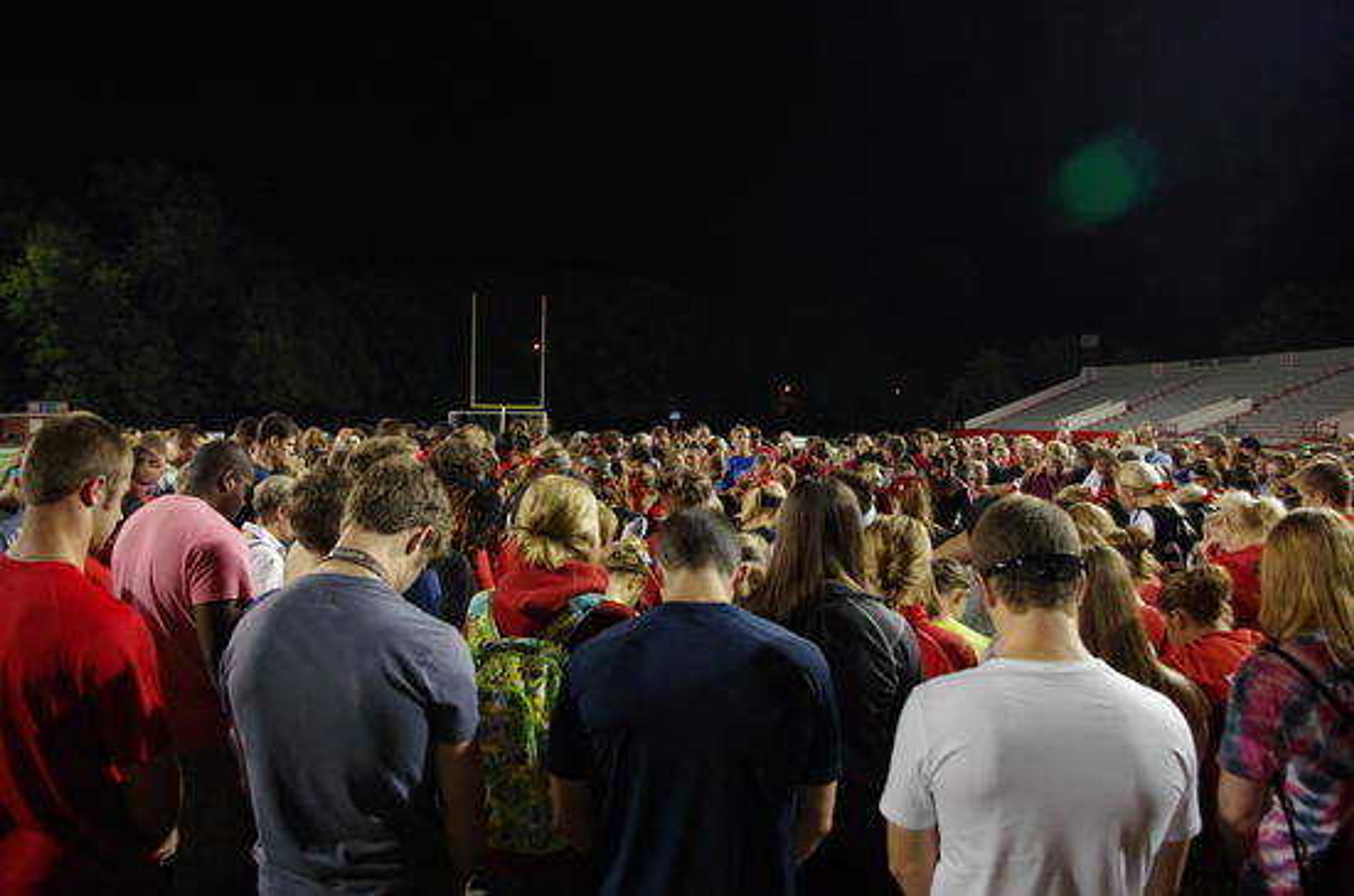 Fans gather on the field at Houck stadium to pray for Meg Herndon. Photo by Nathan Hamilton