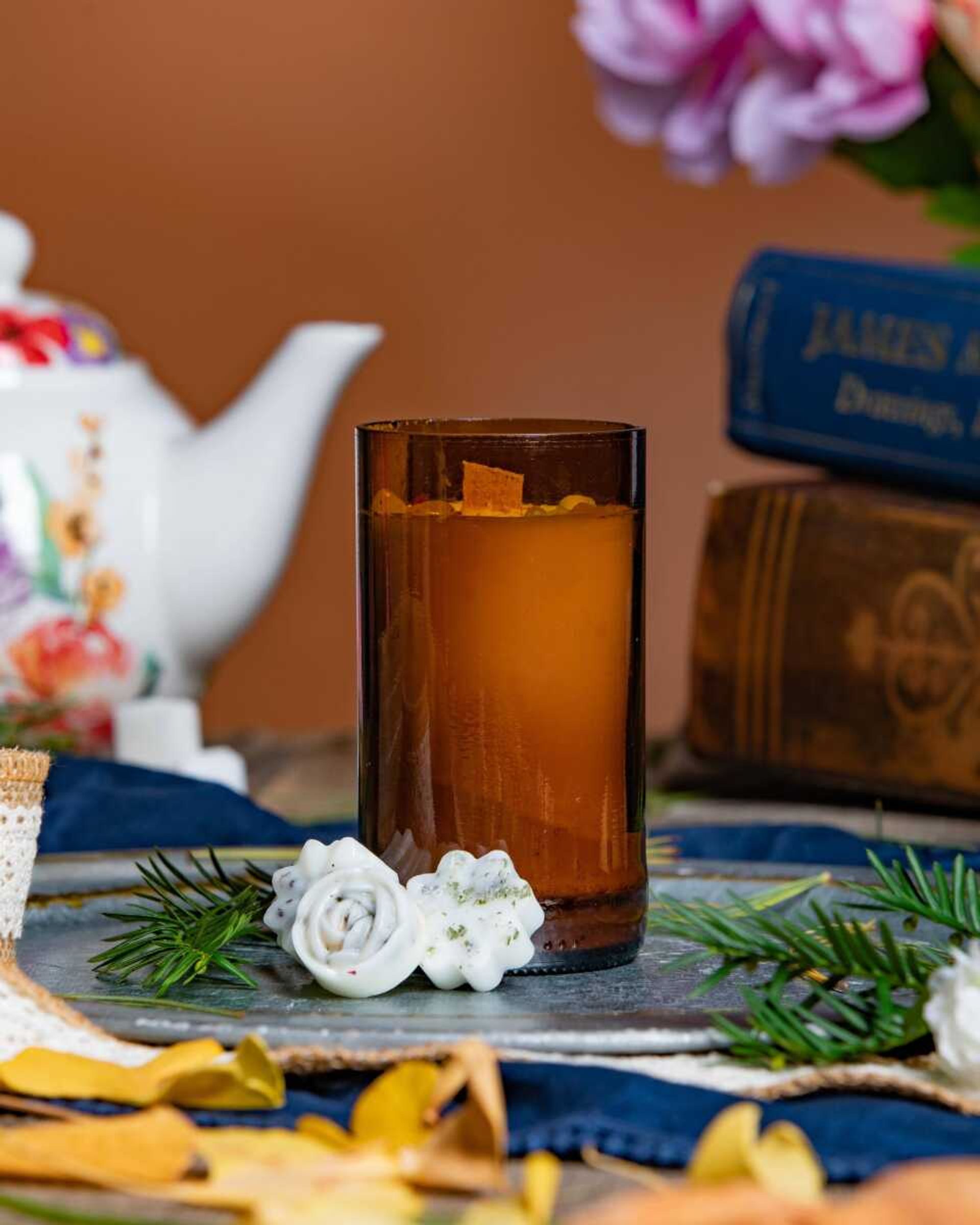 Tea time scented candles are placed among tea pots and flowers. Other scents available include haunted forest, certified lavender boy and apple pie. 