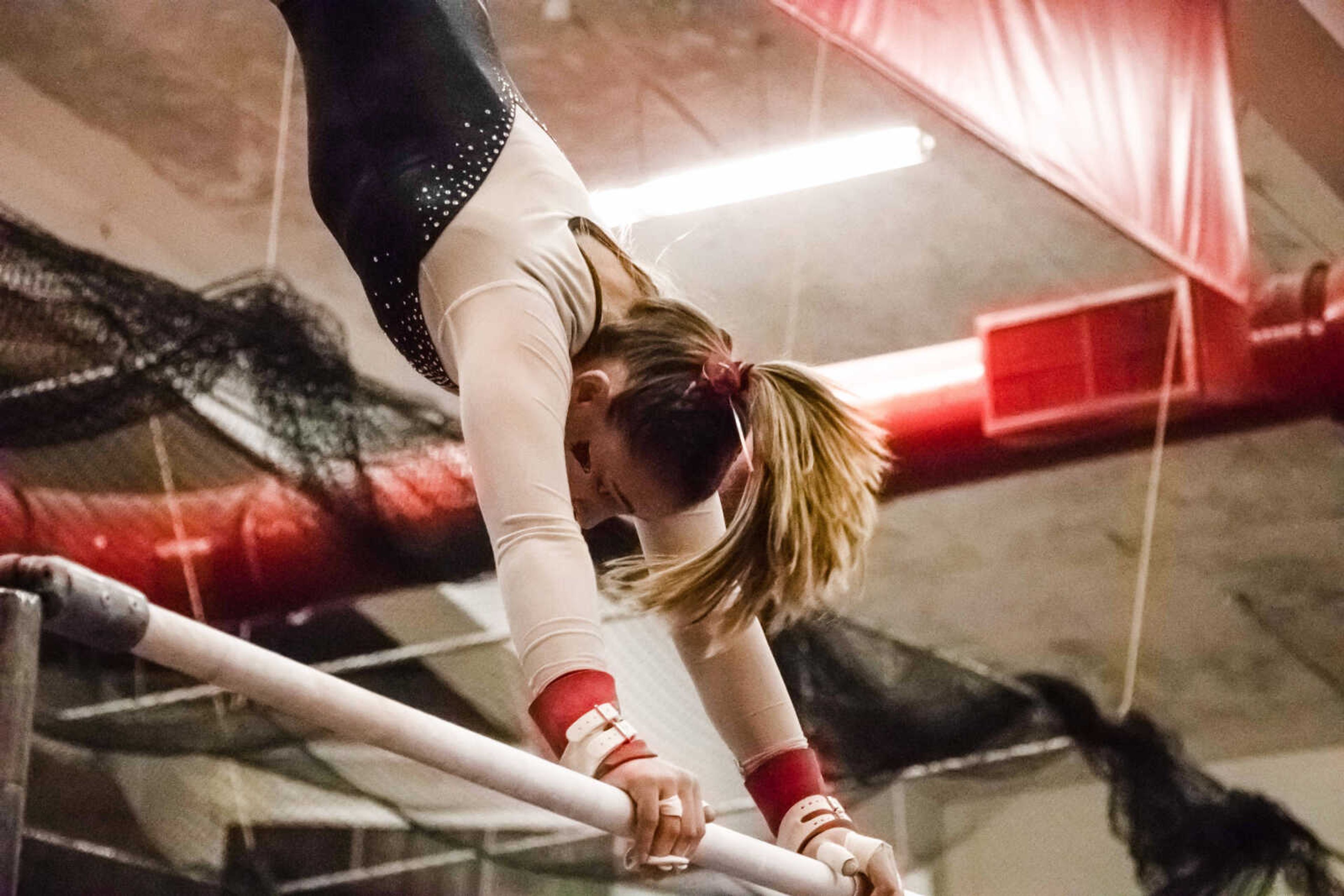 Junior Mackenzie Slee performs her routine on the uneven bars at Houck Field House on Jan. 18, where she finished with a score of 8.725, placing 11th in the event and fifth among Redhawks.