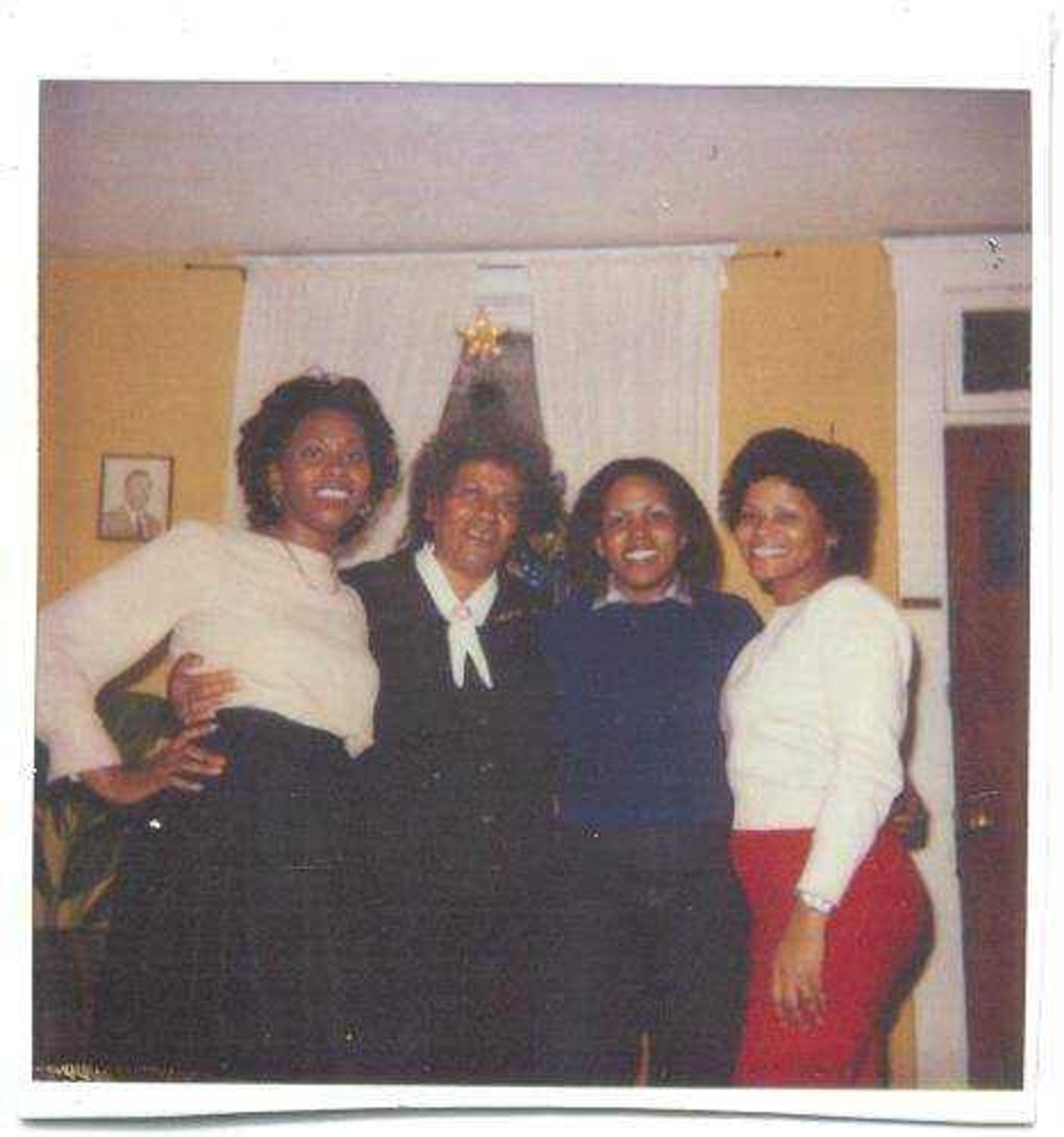 Dean (pictured wearing blue) poses with her mother and two sisters in 1977.