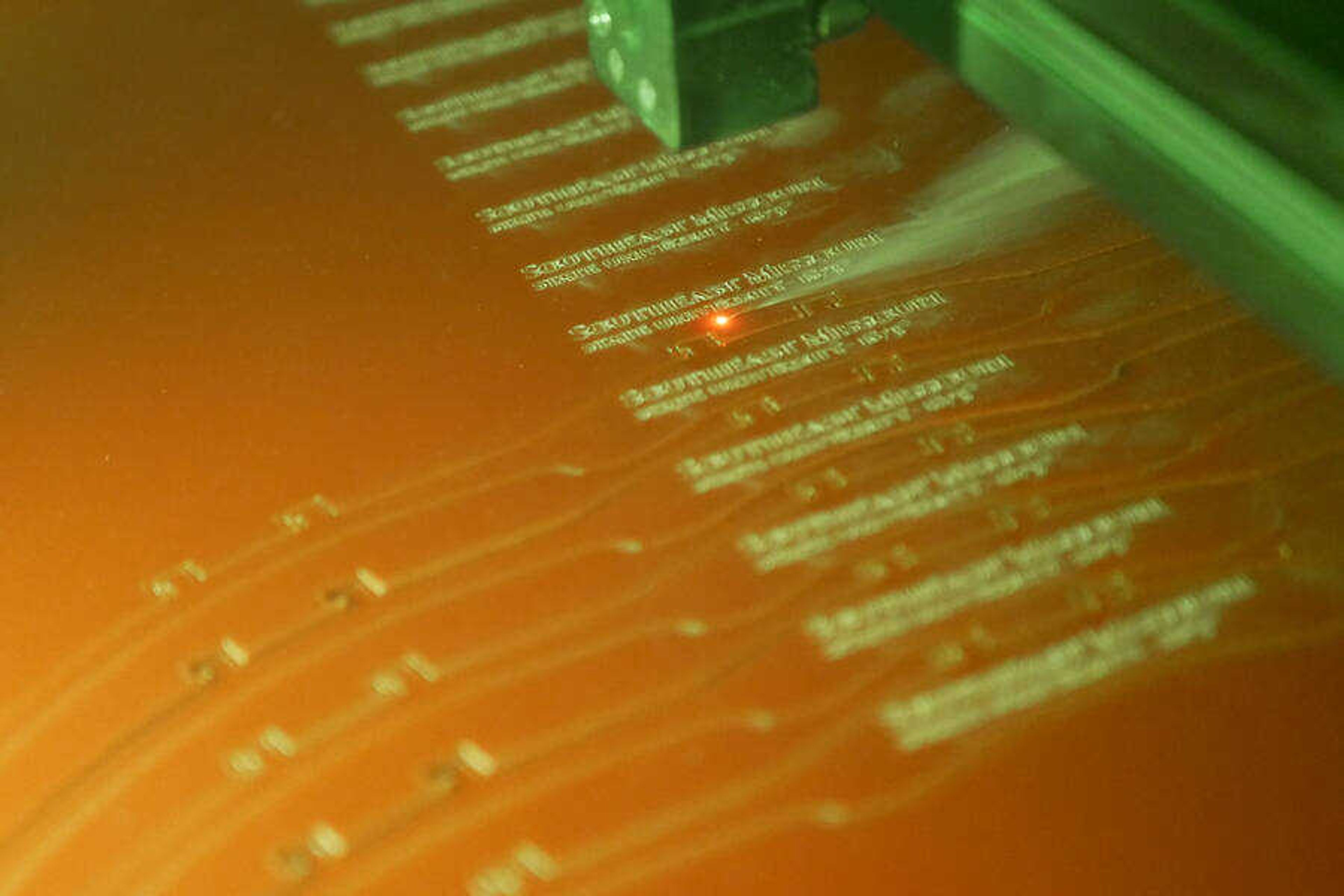A laser carves out engraved headbands for face shields at the Seabaugh Polytechnic Building. The face shields will be distributed to staff members on campus.