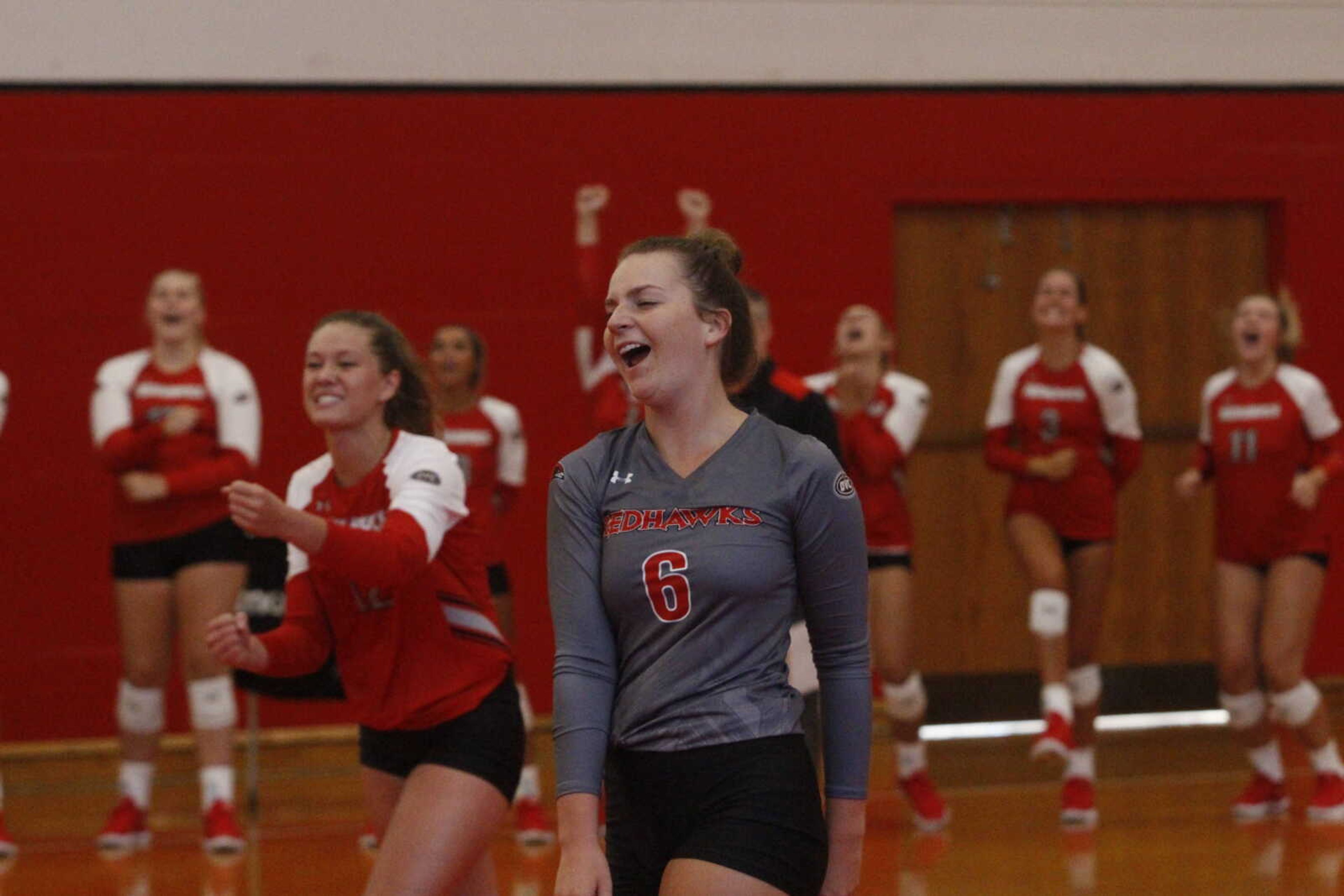 Sophomore defensive specialist Ally Dion, number six, and junior outside hitter Mikayla Kuhlmann celebrate after a Redhawks score during an exhibition match against Missouri Baptist.