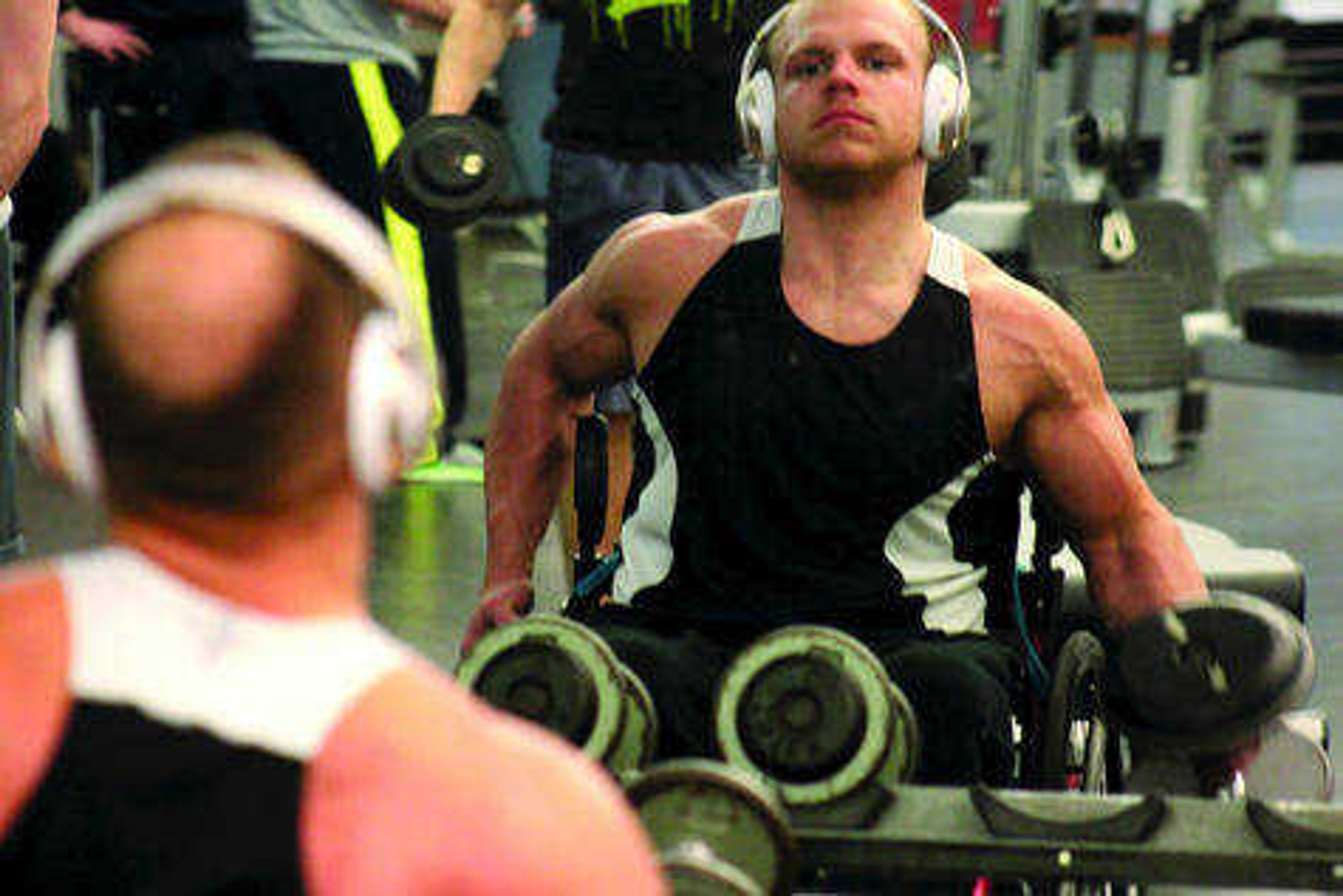 Brandon Strop doing dumbbell curls at the Student Recreation Center-North. Photo by Michael Stamper
