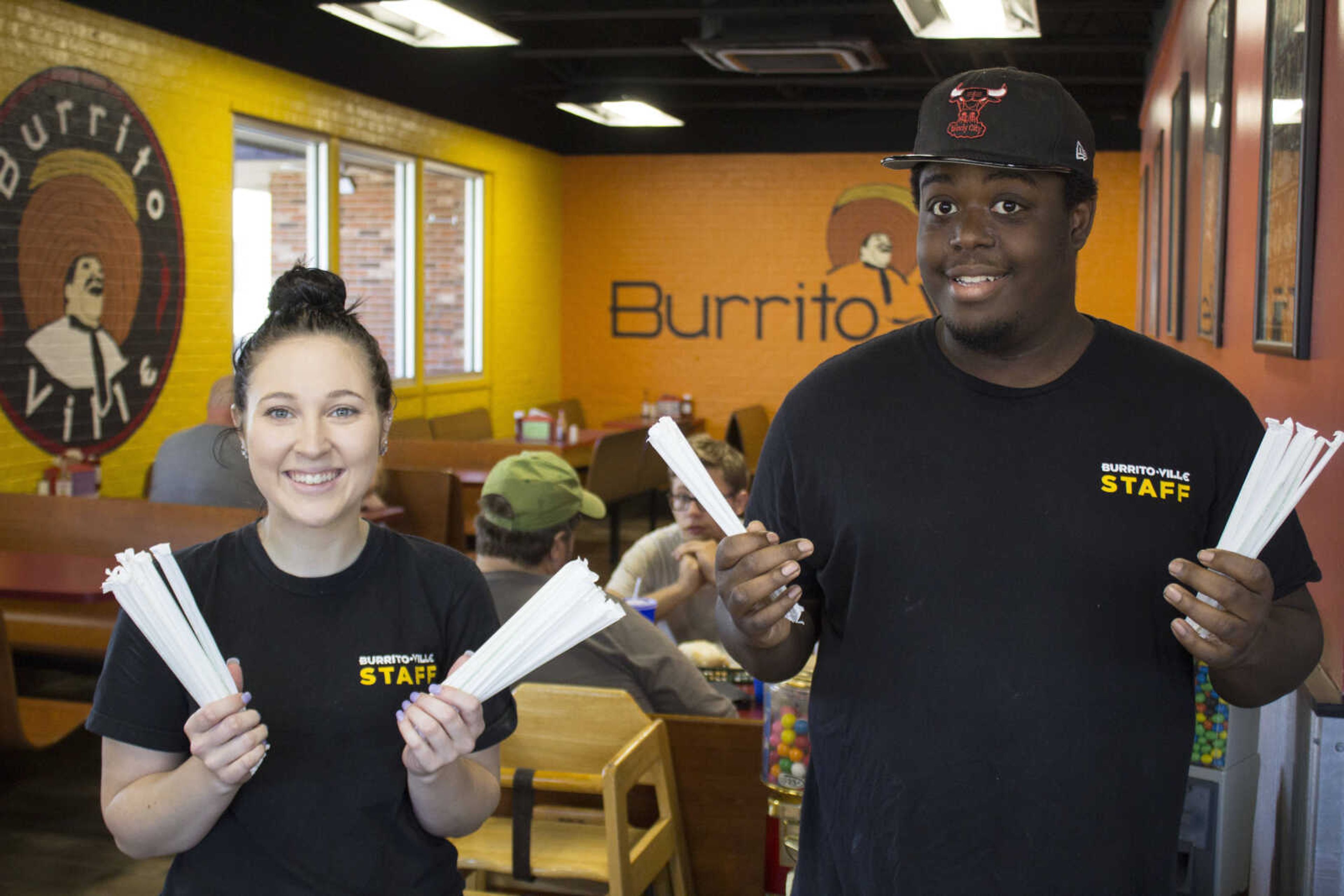 Burrito-Ville staffers Michael Reece and Anastasia Fundis promoting the new biodegradable straws.