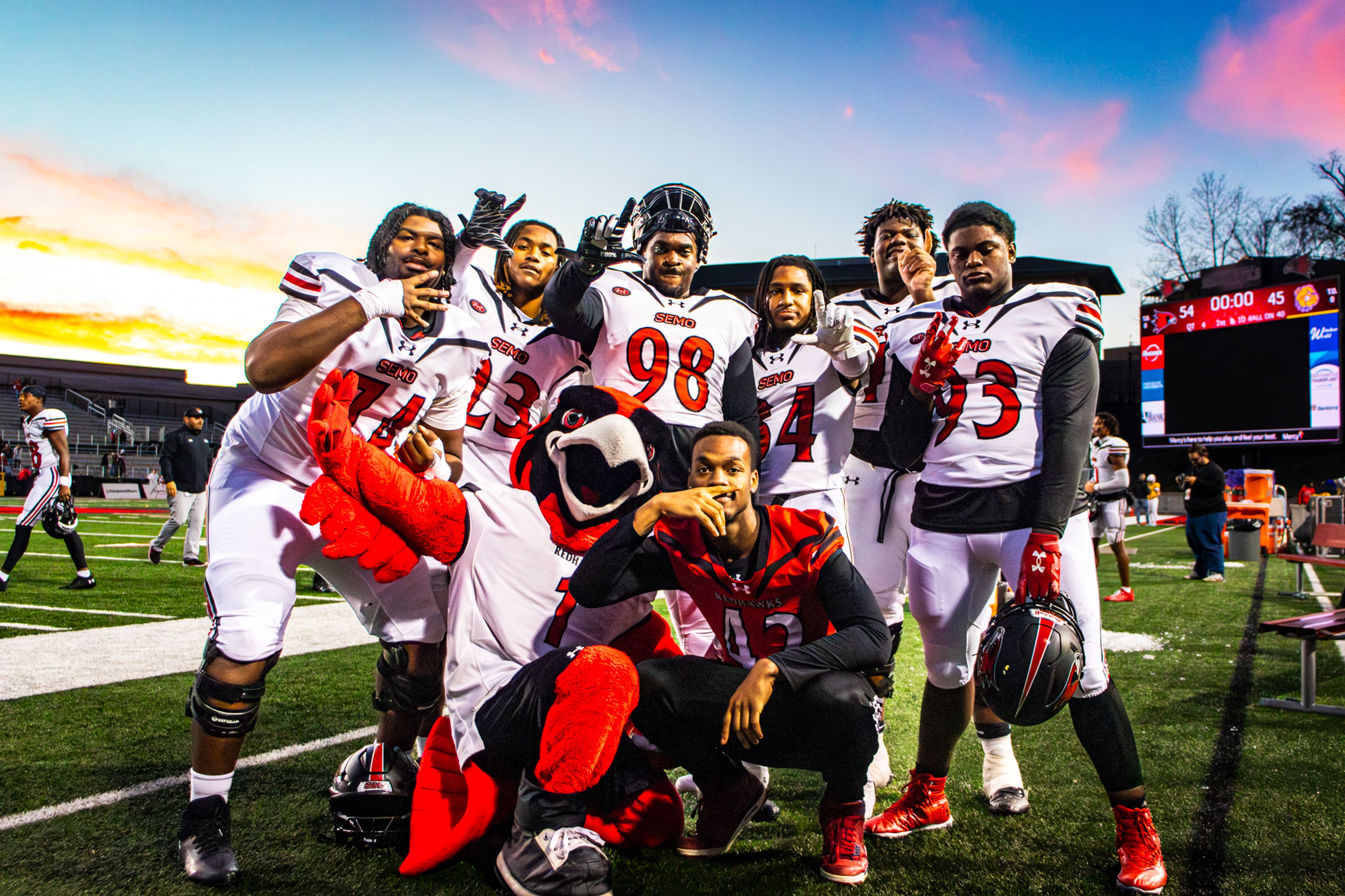 SEMO football players pose with SEMO's Mascot "Rowdy" while celebrating a win against Western Illinois University