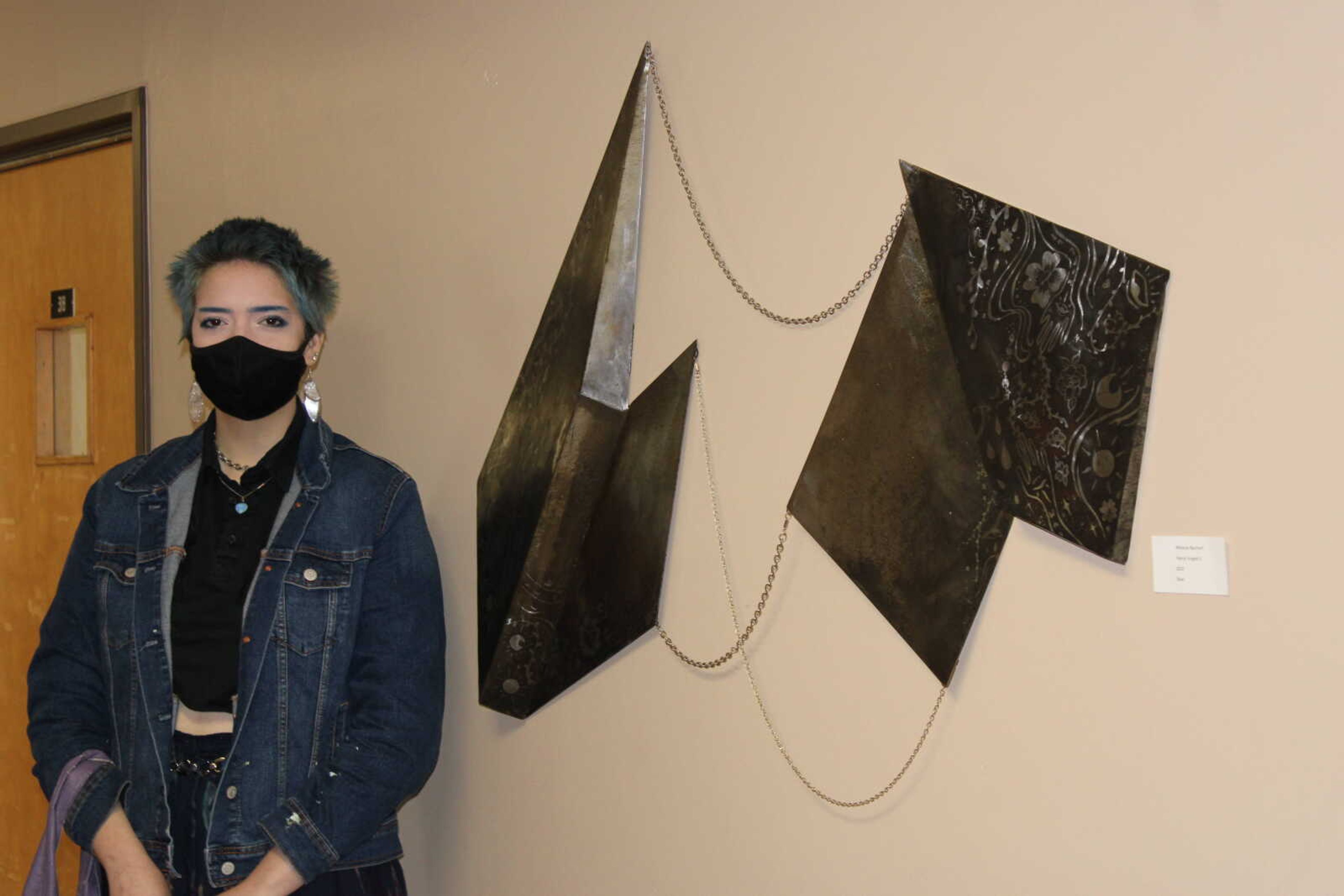 Sculpture senior Melanie Reichert won best in show at the Brandt student art exhibition on April 18. The piece titled, "Faerie Forged II" included a set of angular steel objects hanging on the wall like a painting, connected by chains.
