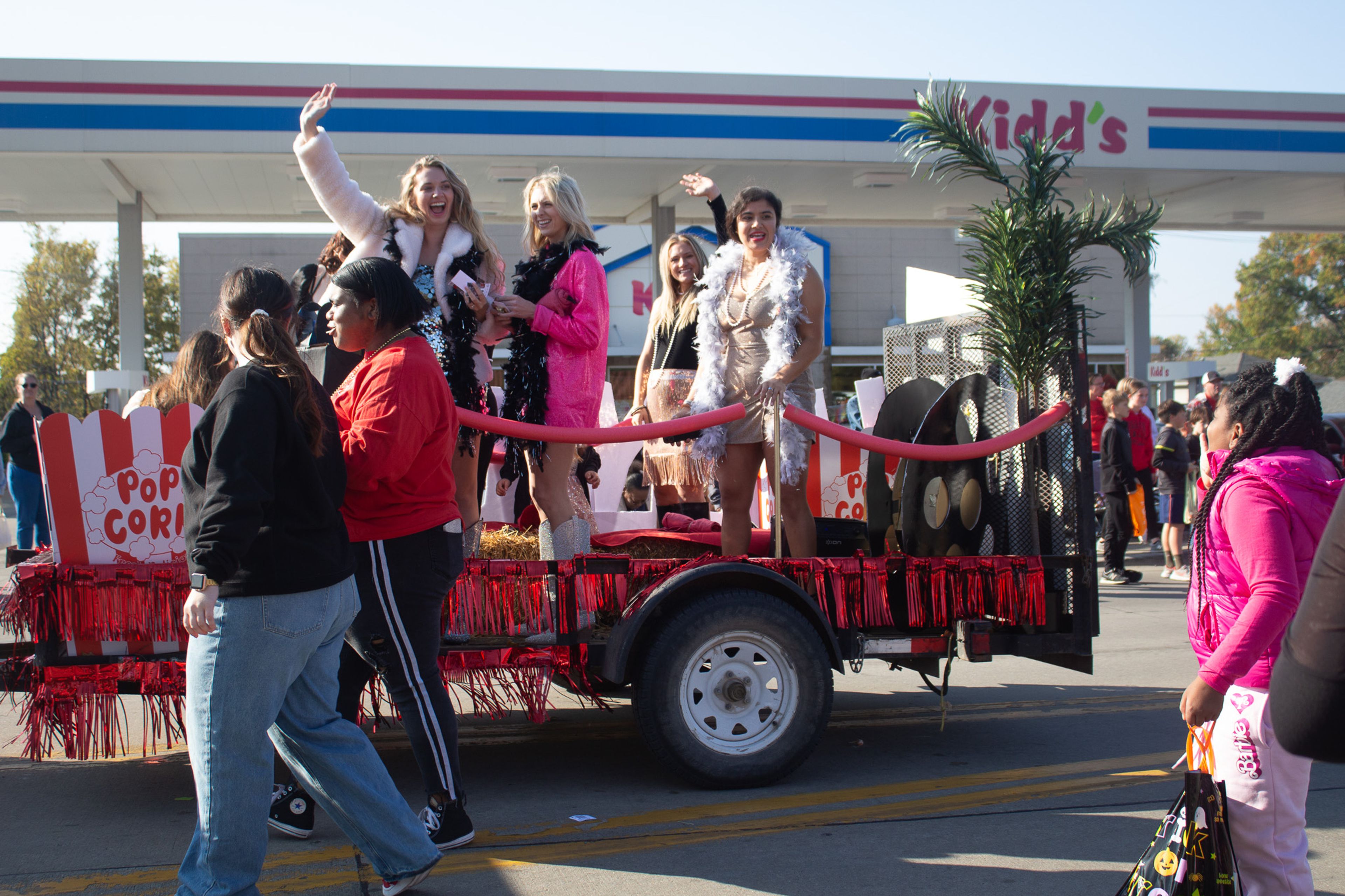 Plato's Closet waving and throwing candy to parade goers.