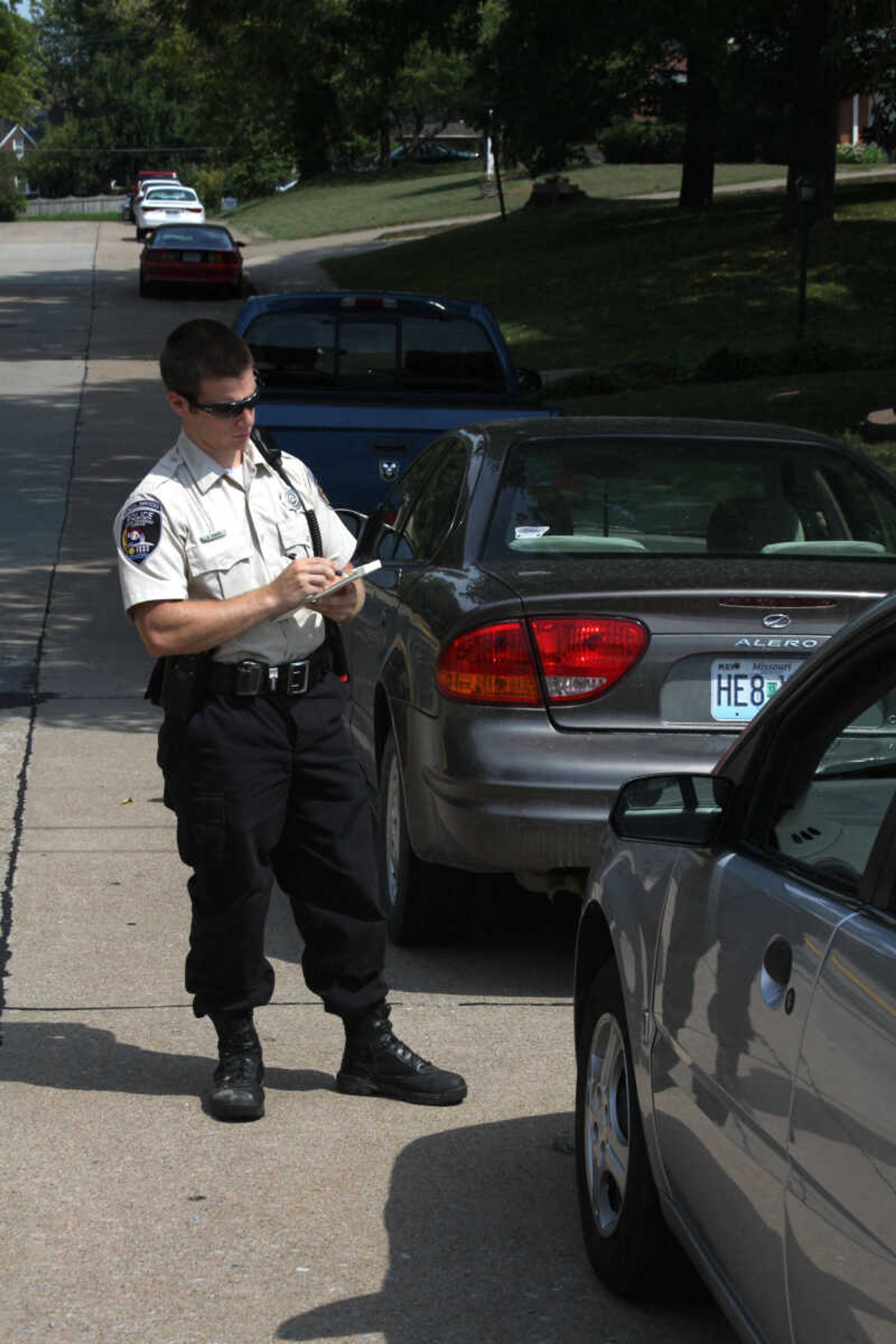 Cape Girardeau officer writing a ticket on one of the streets near campus. Photo by Kelso Hope