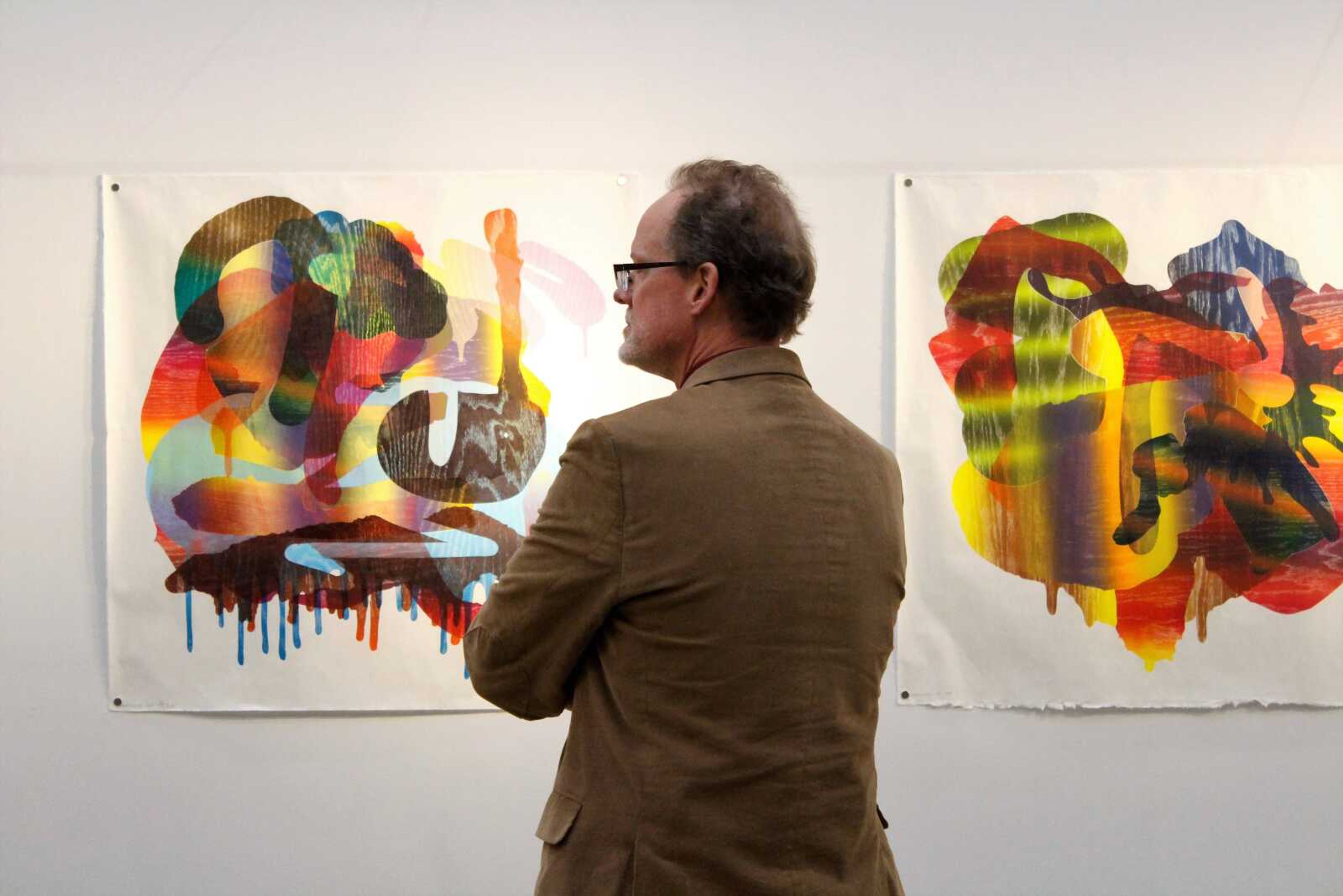 A patron observes an artwork piece displayed at River Campus during First Friday with the Arts on Nov. 3.