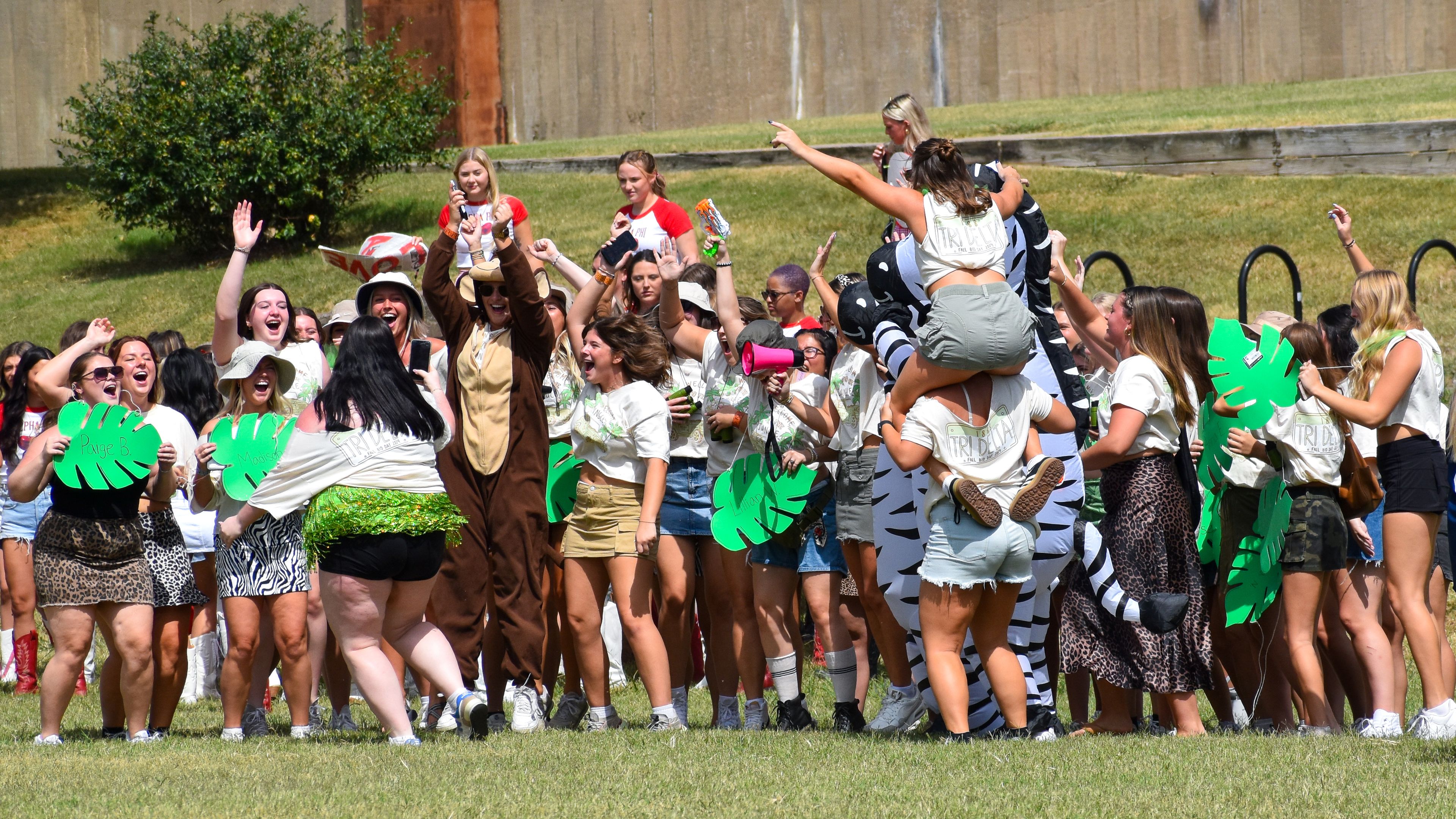 Delta Delta Delta sorority members participate in a chant at Parker Field.