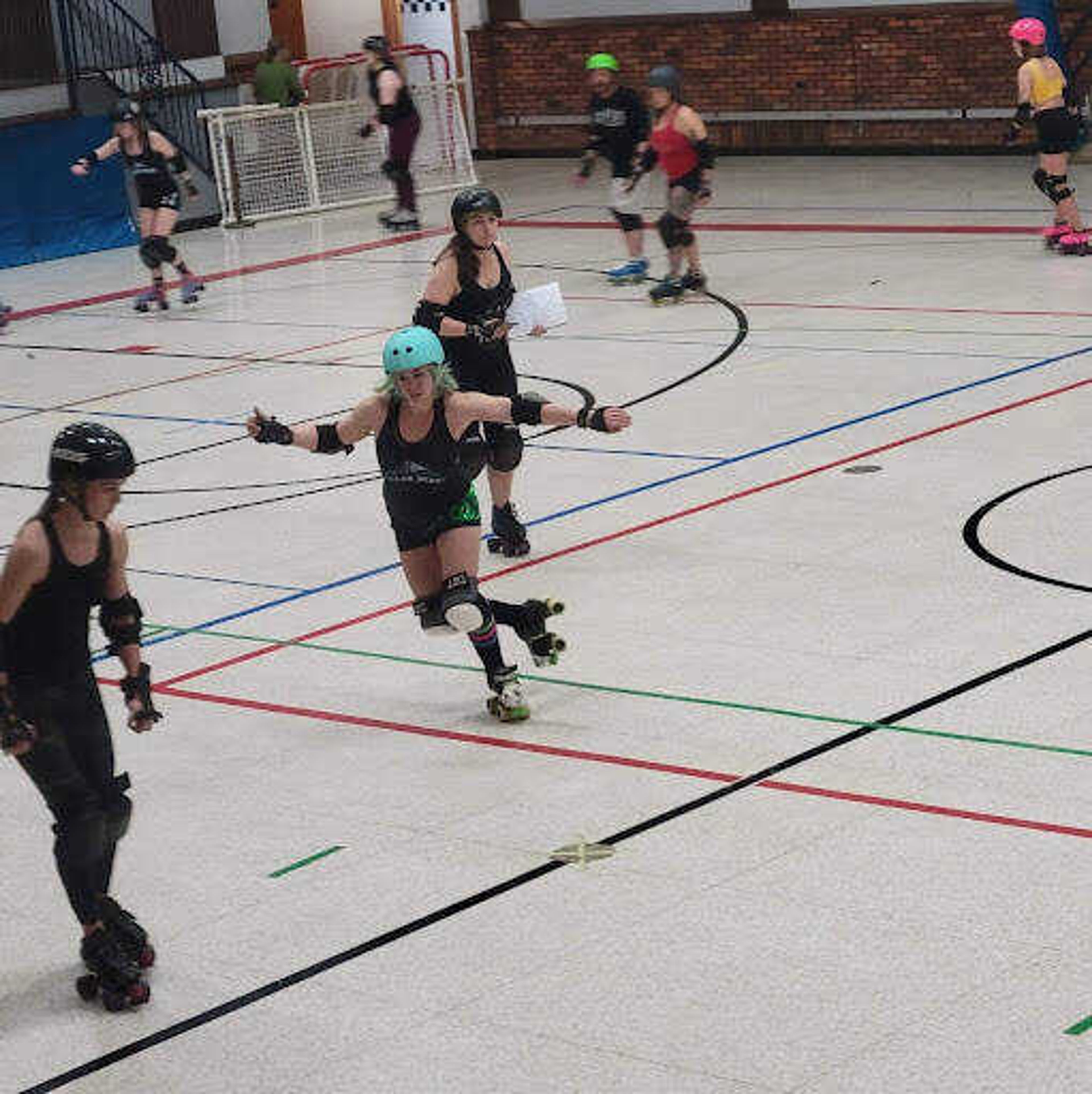 Roller Derby member “Deathstrike” warms up. She is one of the more experienced skaters on the team. 
