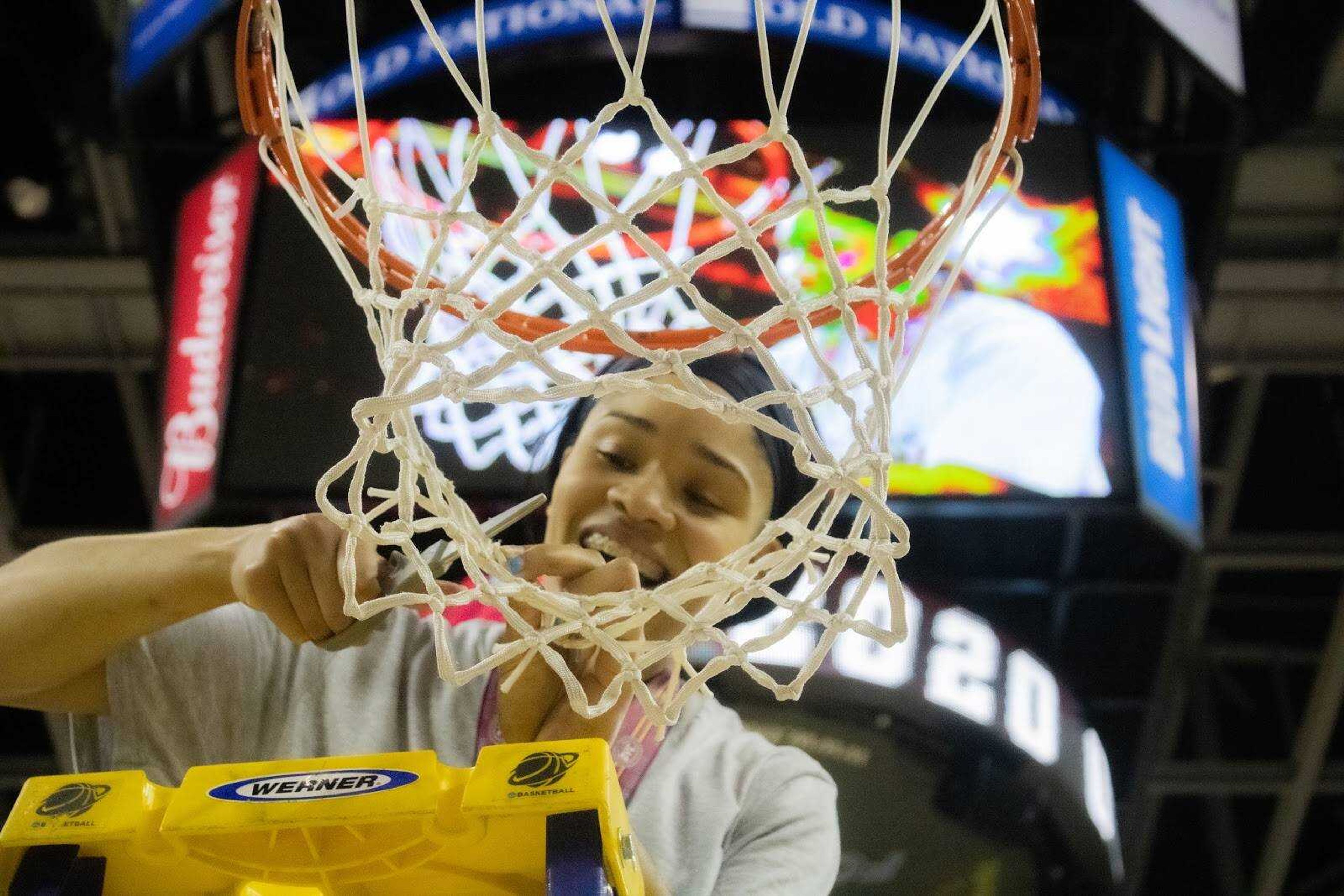 Junior Tesia Thompson cuts down the nets after the Redhawk’s Ohio Valley Conference Championship win on March 7.