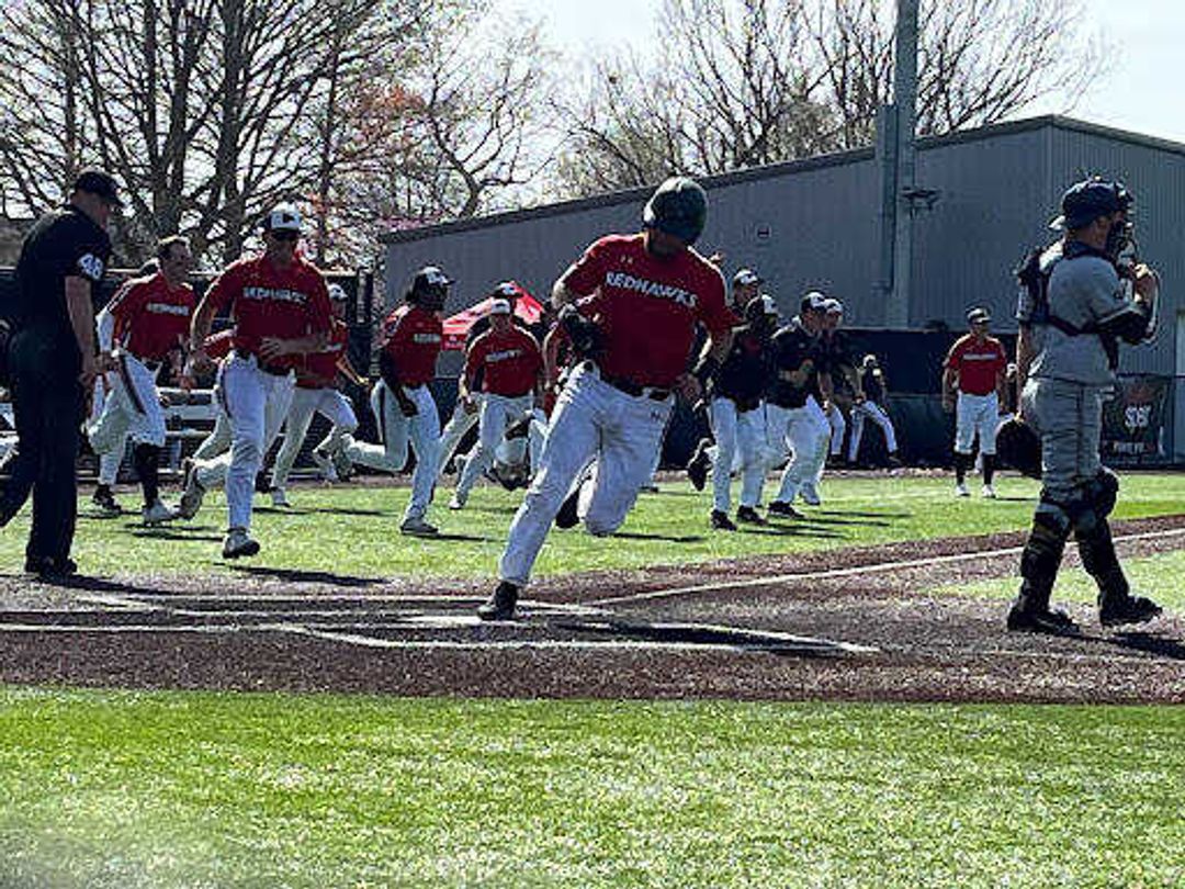 Catcher Andrew Keck scores the winning run as the team rushes the field in a walkoff win against Murray State on April 10.