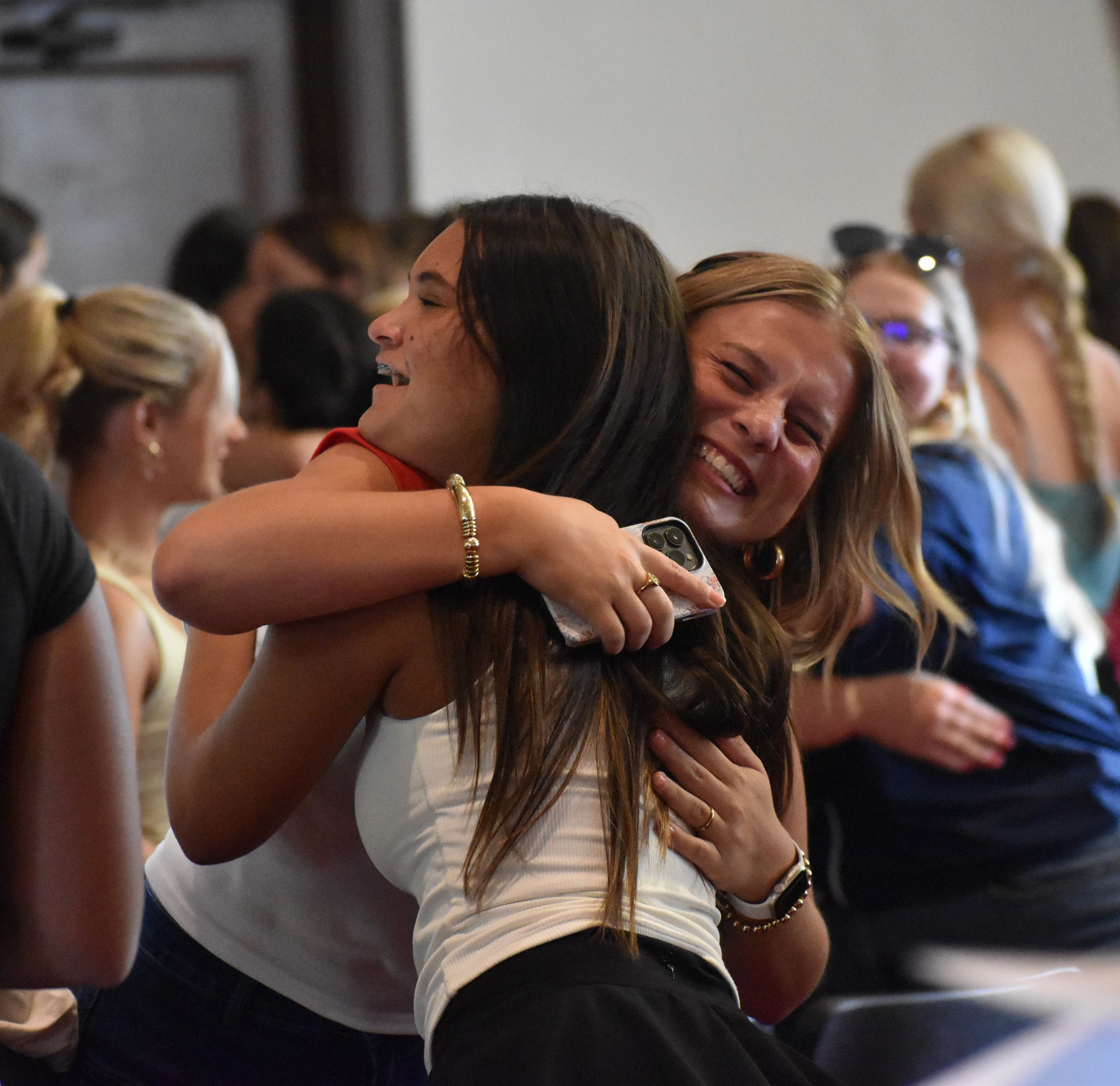 New members celebrate after opening their bid day cards.