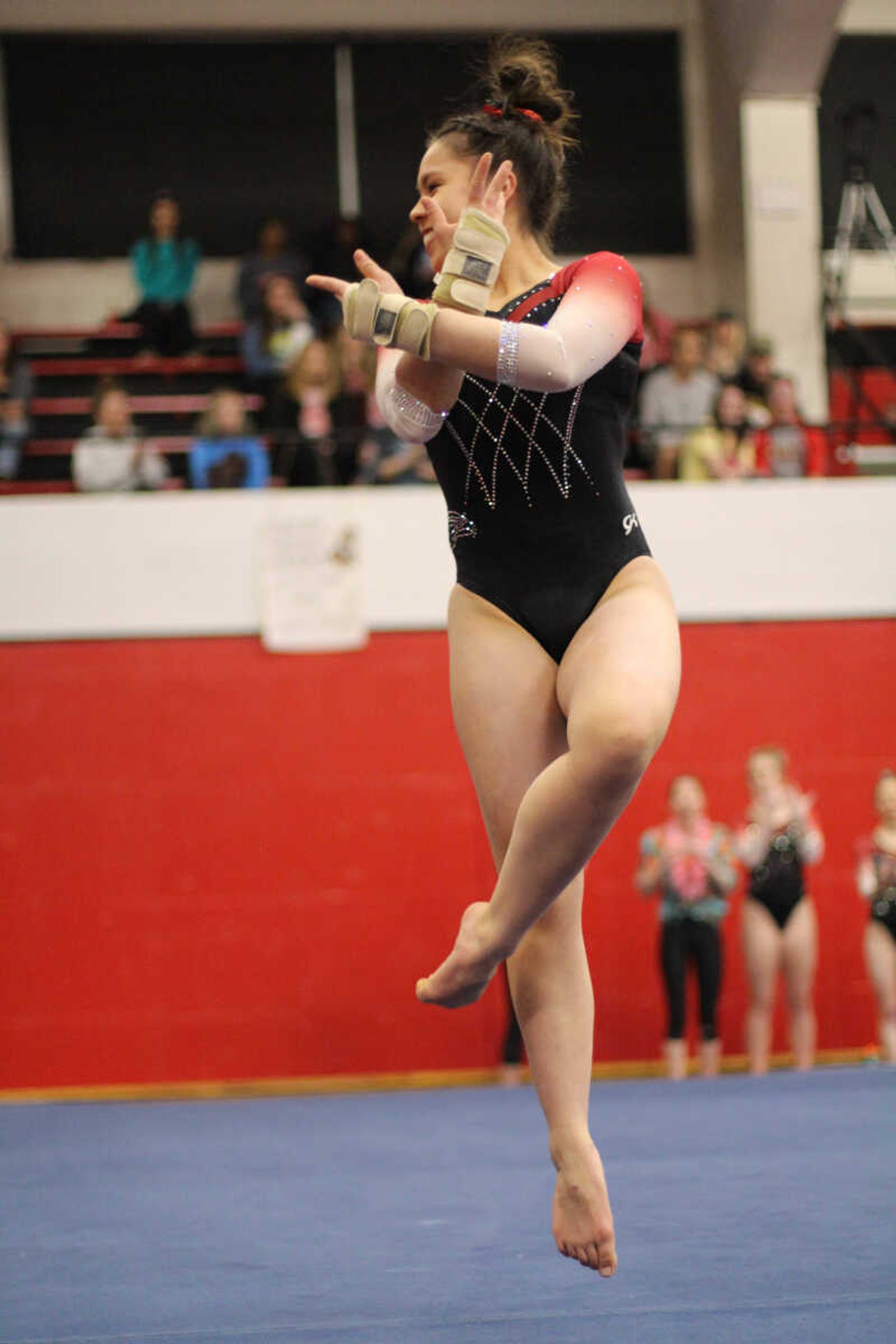 Freshman Anna Kaziska shows some flair and elevates during her floor routine Friday, March 1, at Houck Field House.